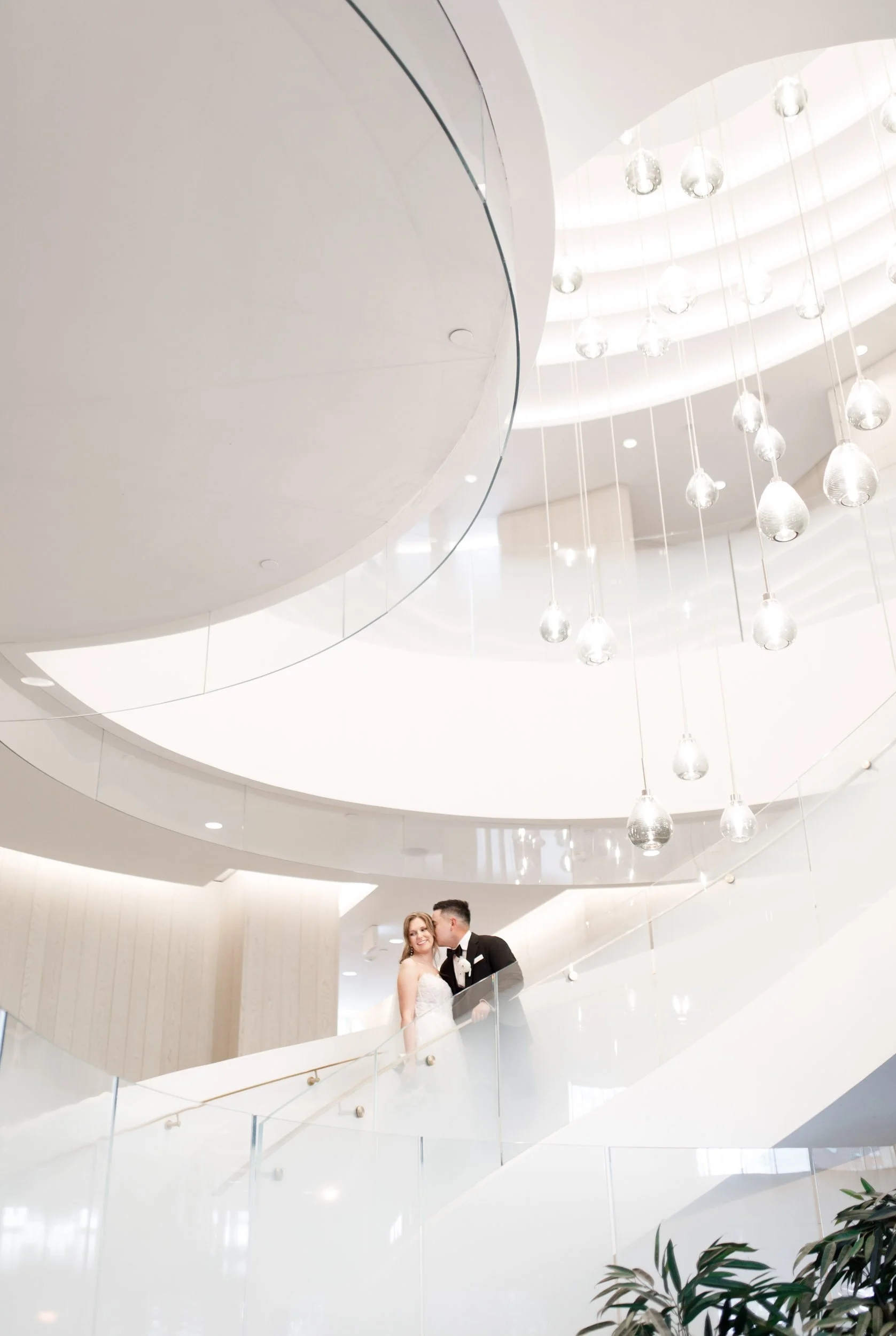 Bride and groom standing on the spiral staircase inside the Pearle Hotel in Burlington Ontario