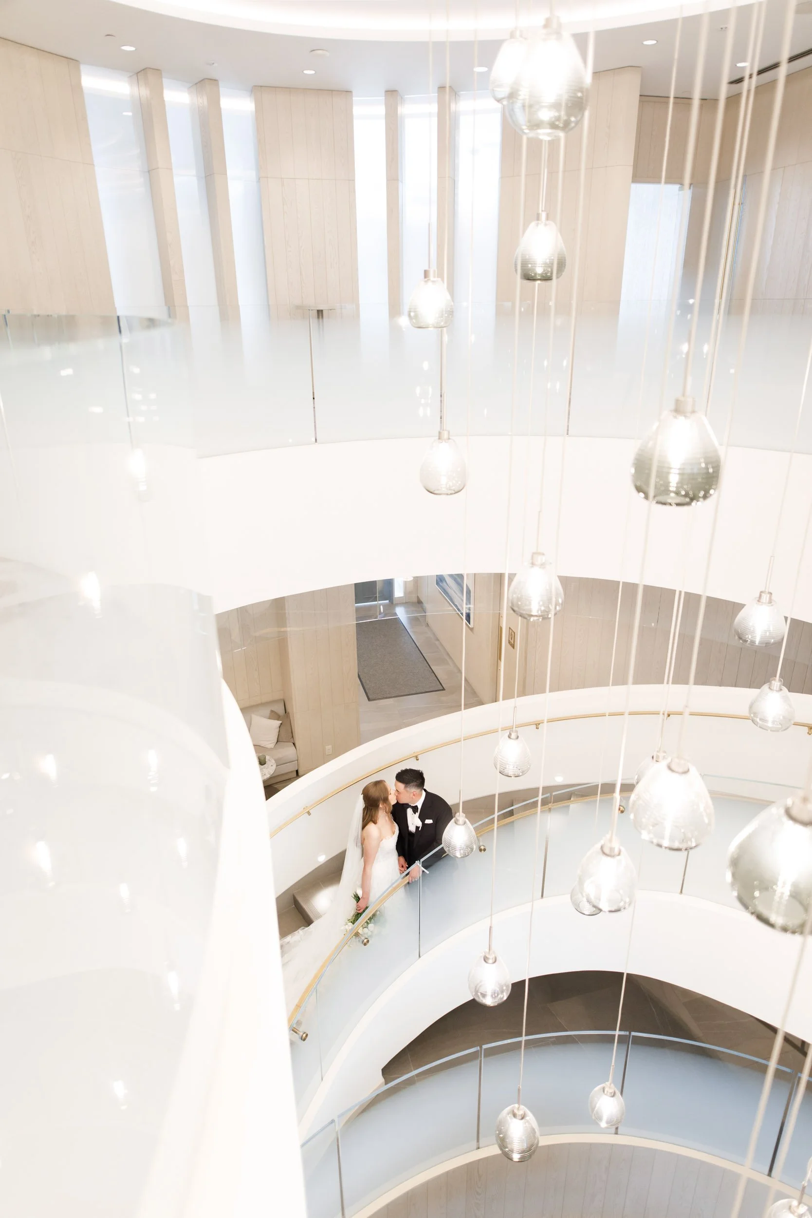 Bride and groom on the curved staircase at the Pearle Hotel in Burlington Ontario