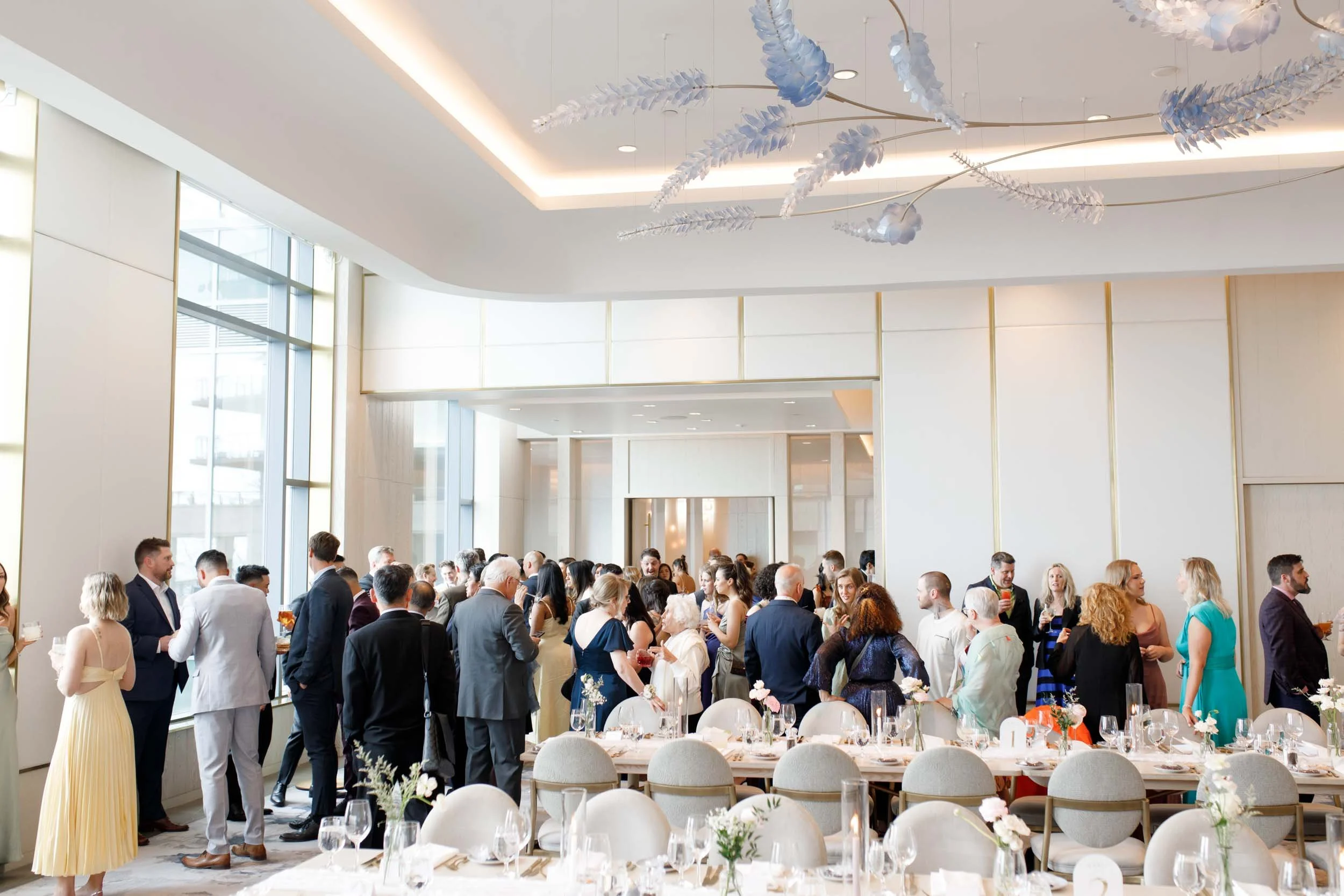 Wedding guests mingling during cocktail hour at the Pearle Hotel in Burlington Ontario