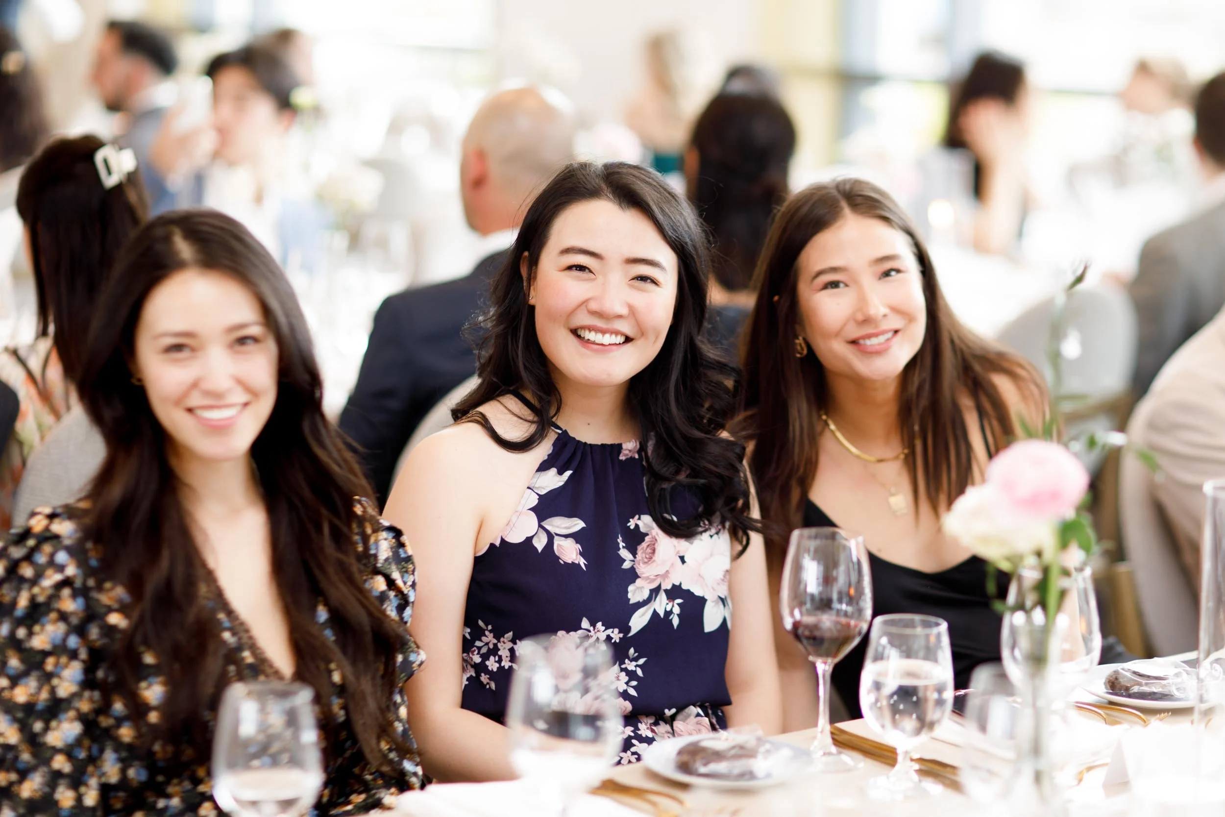 Group of wedding guests smiling at a Pearle Hotel wedding reception in Burlington Ontario