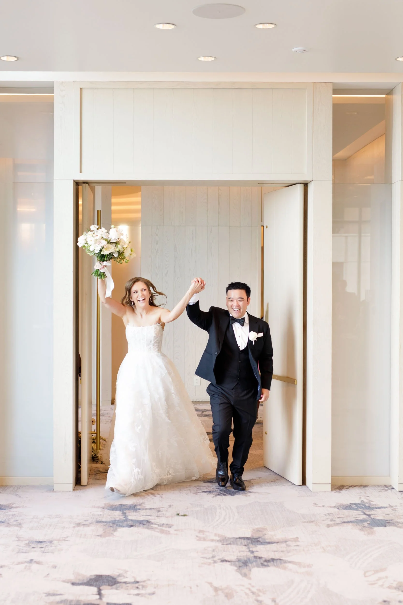 Bride and groom entering their wedding reception at the Pearle Hotel in Burlington Ontario