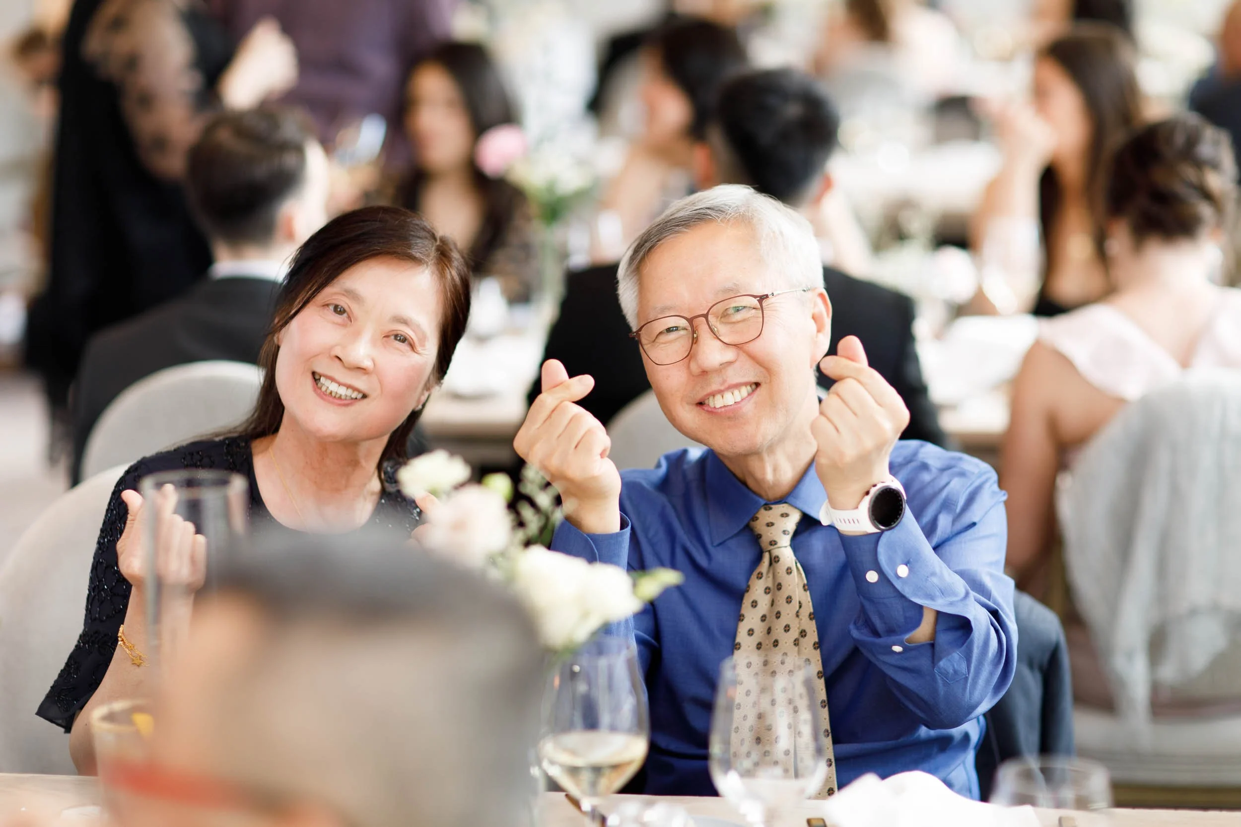 Wedding guests smiling during a Pearle Hotel wedding reception in Burlington Ontario