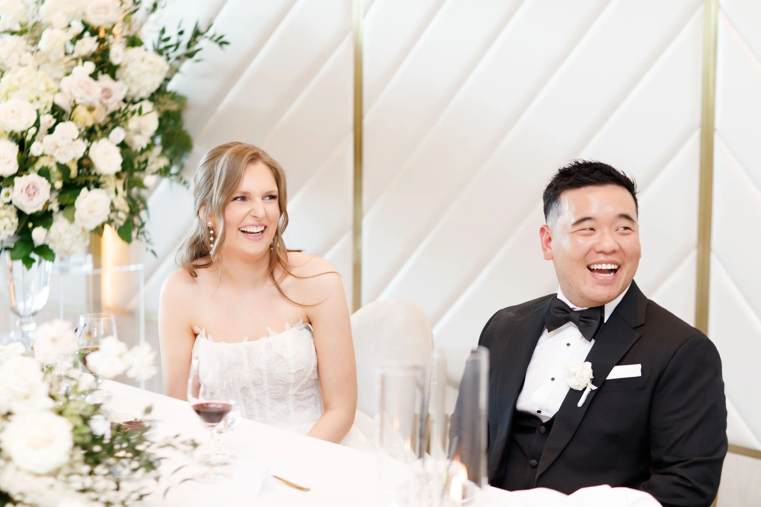 Bride and groom laughing at the head table during their Pearle Hotel wedding in Burlington Ontario
