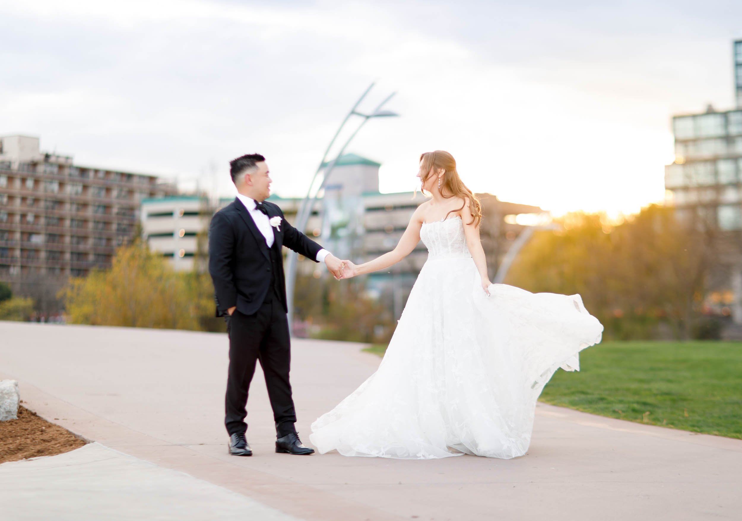 Bride and groom twirling together outside the Pearle Hotel in Burlington Ontario