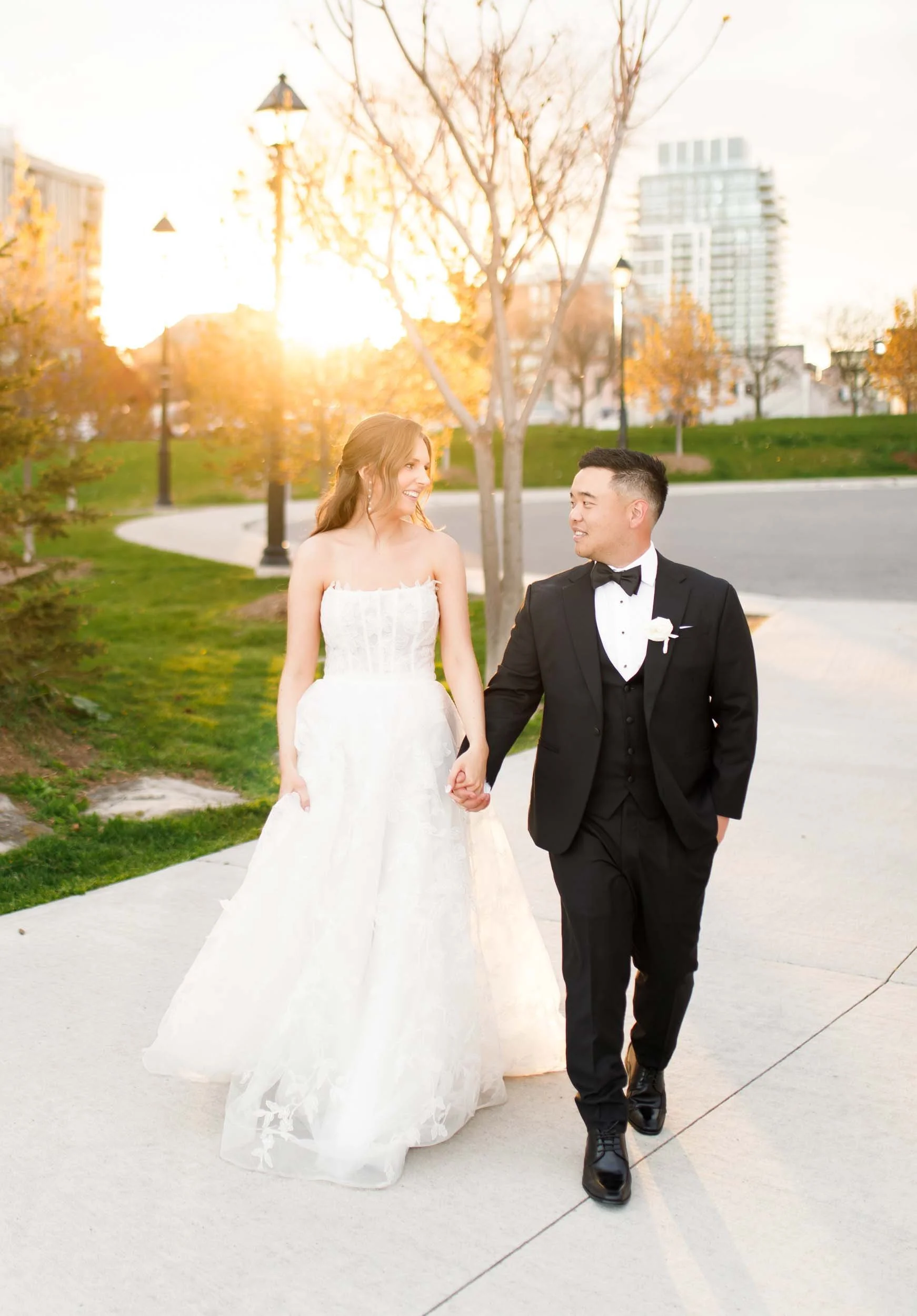 Bride and groom strolling together at sunset in Burlington Ontario
