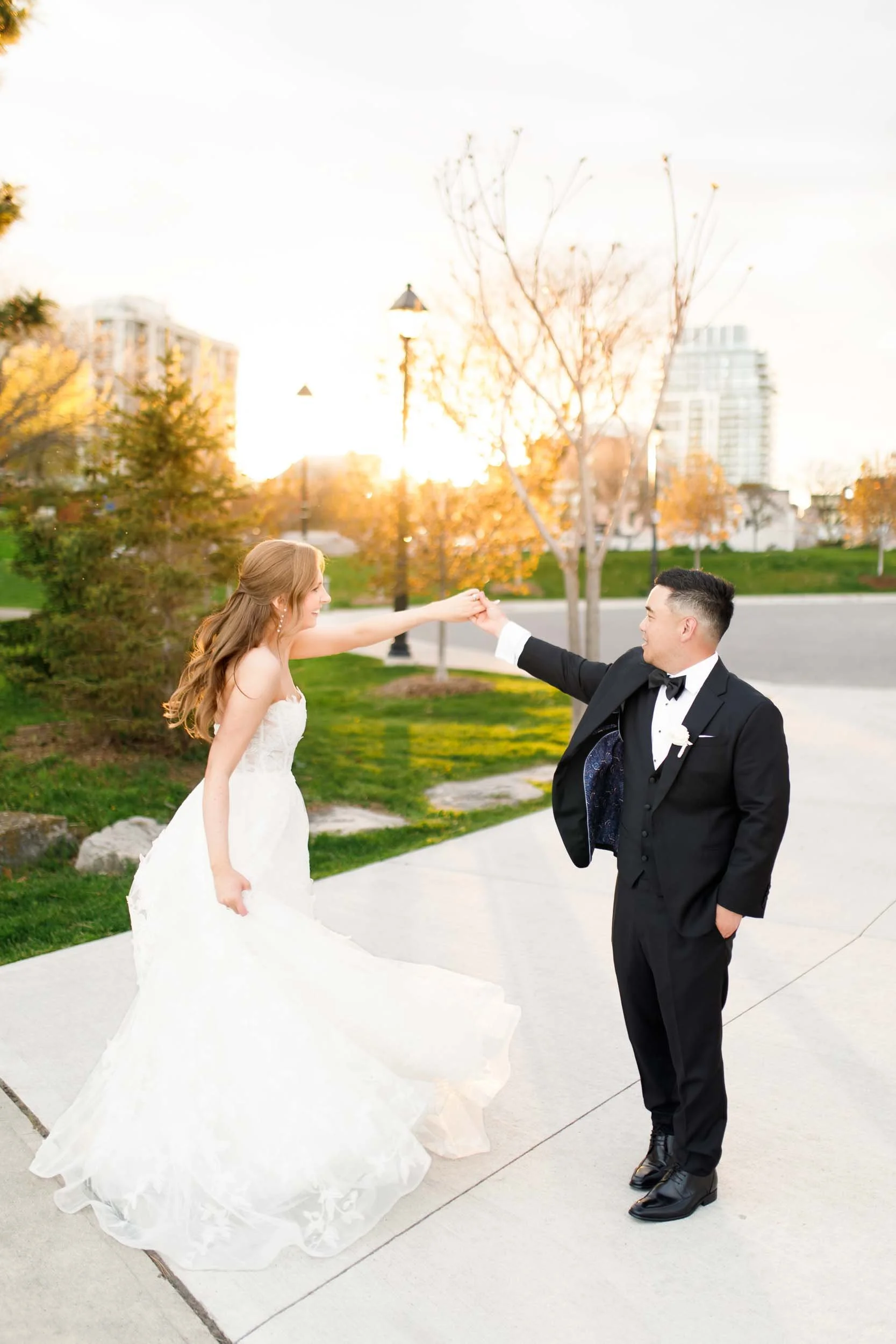 Bride and groom dancing together outdoors at sunset in Burlington Ontario