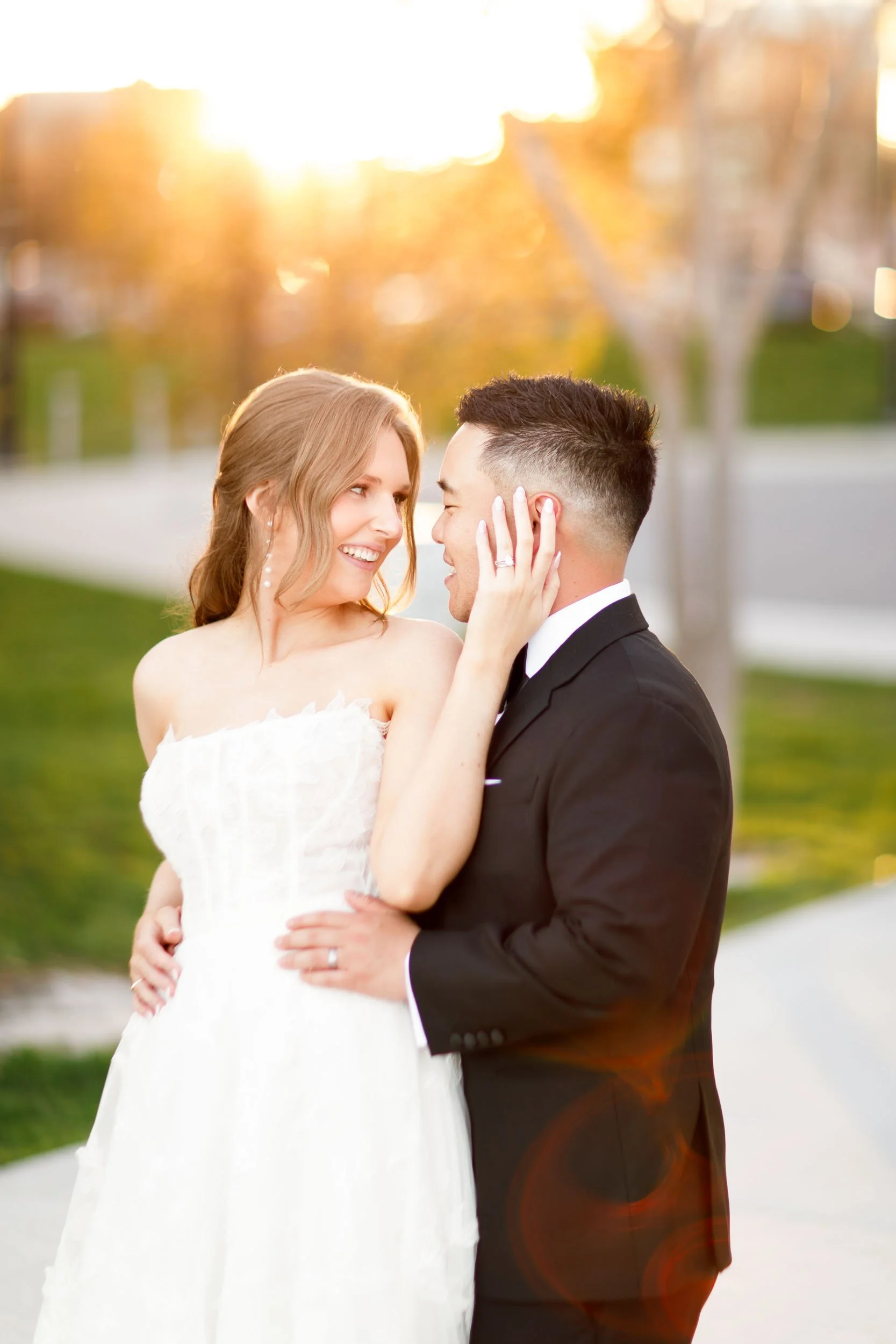 Bride and groom embracing during golden hour in Burlington Ontario