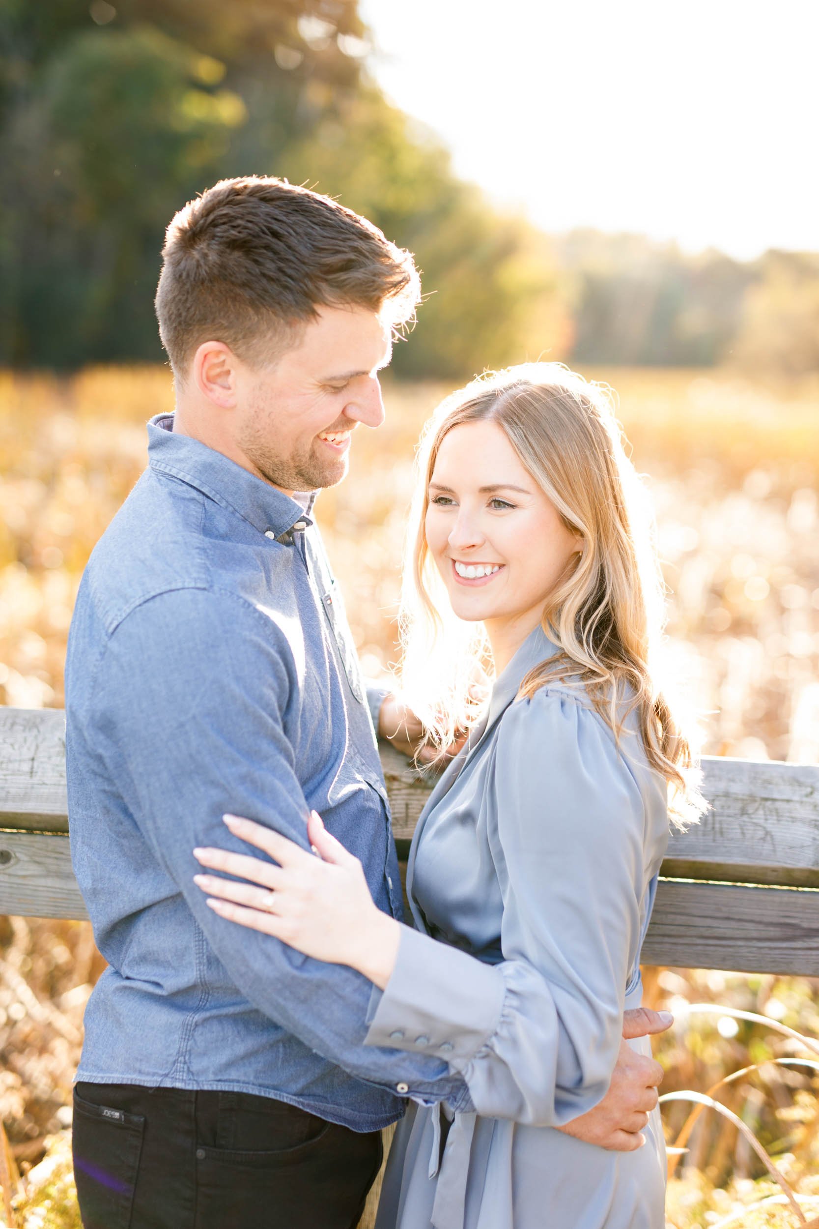 Engaged couple standing together during an outdoor engagement session at Grindstone Marsh Trail in Burlington Ontario