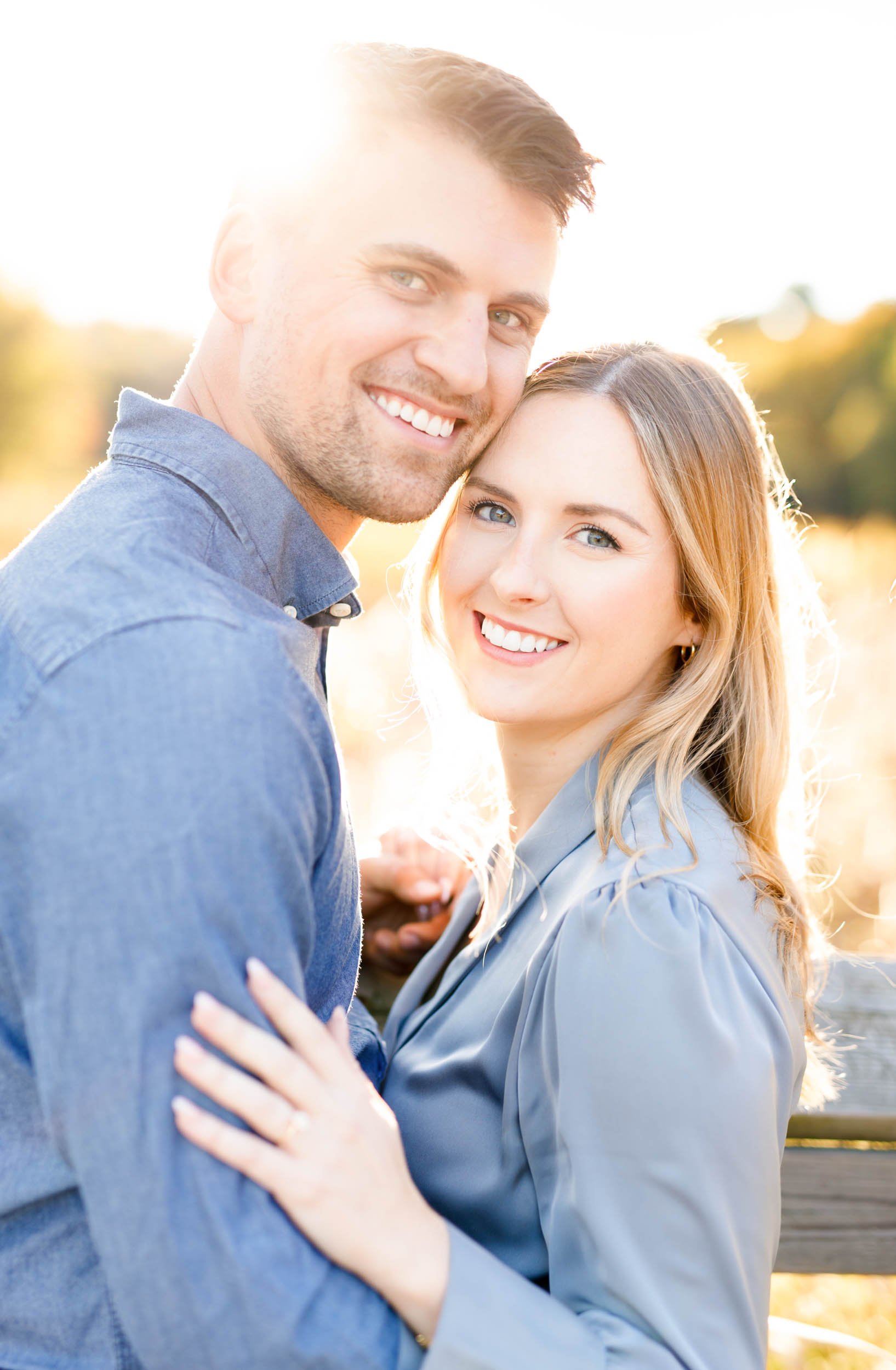 Smiling engaged couple in a golden hour engagement portrait at Grindstone Marsh Trail in Burlington Ontario