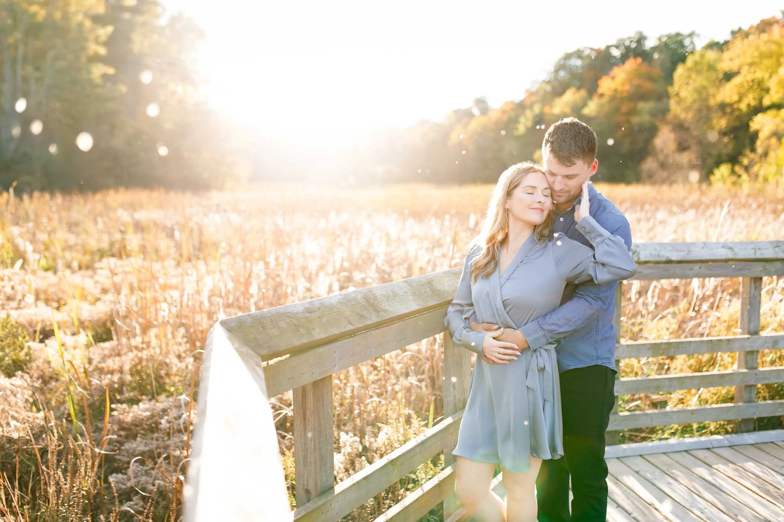 Romantic engagement portrait on the boardwalk at Grindstone Marsh Trail in Burlington, Ontario