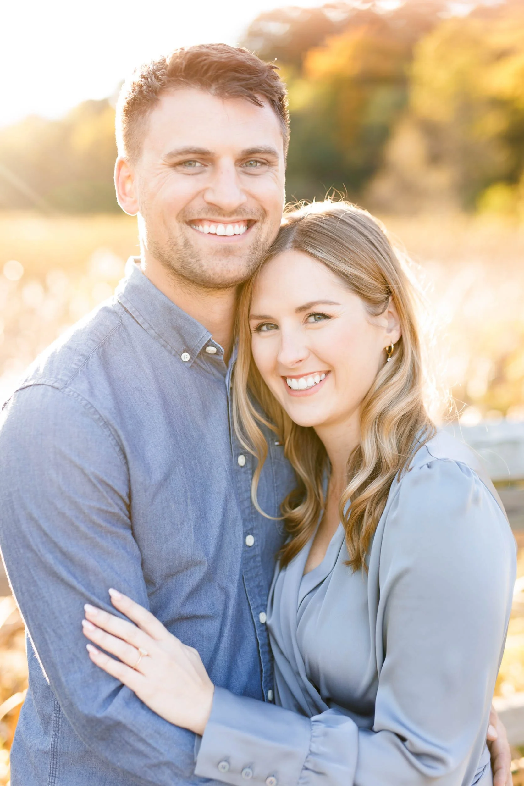 Smiling engaged couple in a close up engagement photo at Grindstone Marsh Trail in Burlington Ontario