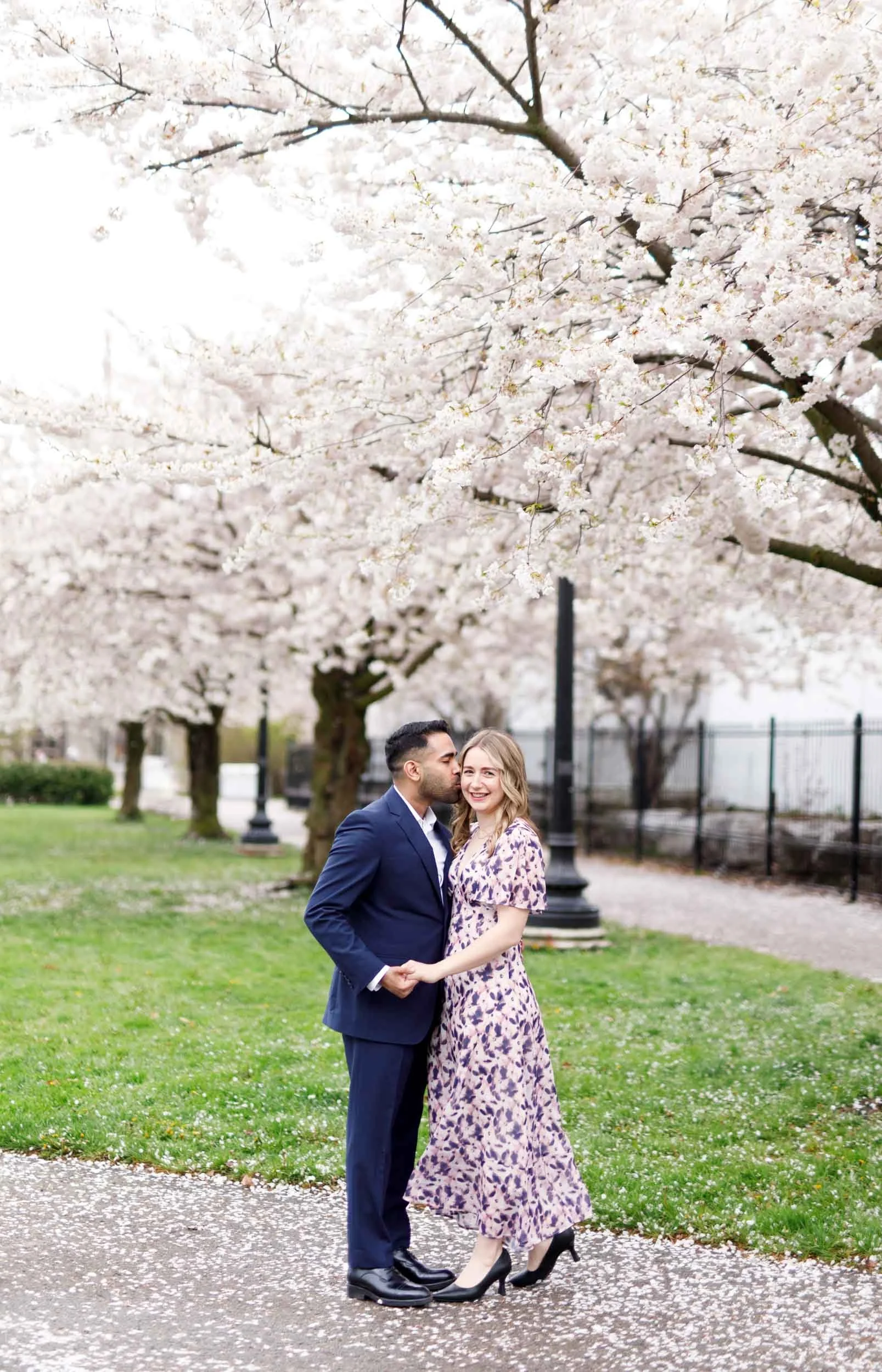 Spring engagement portrait beneath cherry blossoms near the Liberty Grand in Toronto (Copy)
