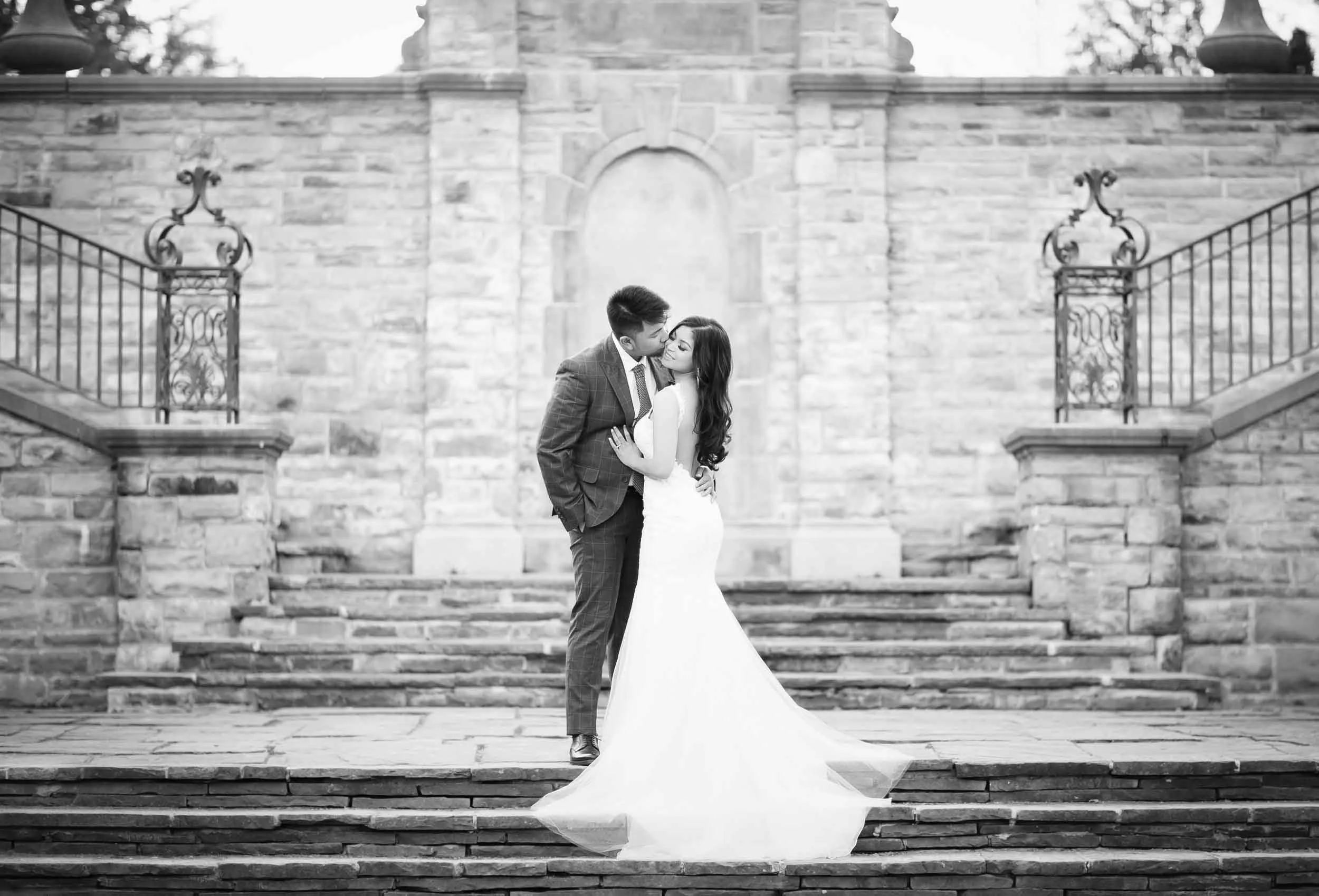Black and white wedding portrait of a couple on the steps of Alexander Muir Memorial Garden in Toronto (Copy)