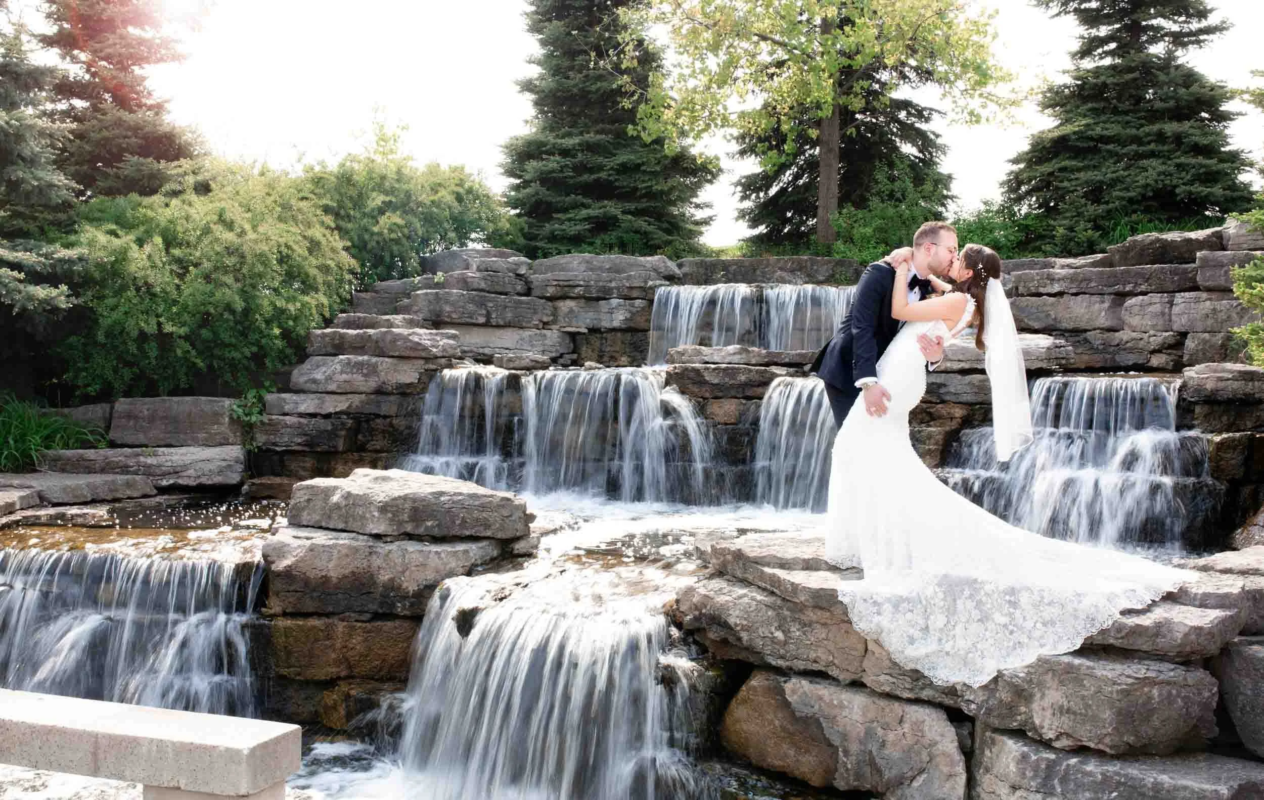 Wedding couple dipping and kissing beside a cascading waterfall at Richmond Green Park (Copy)