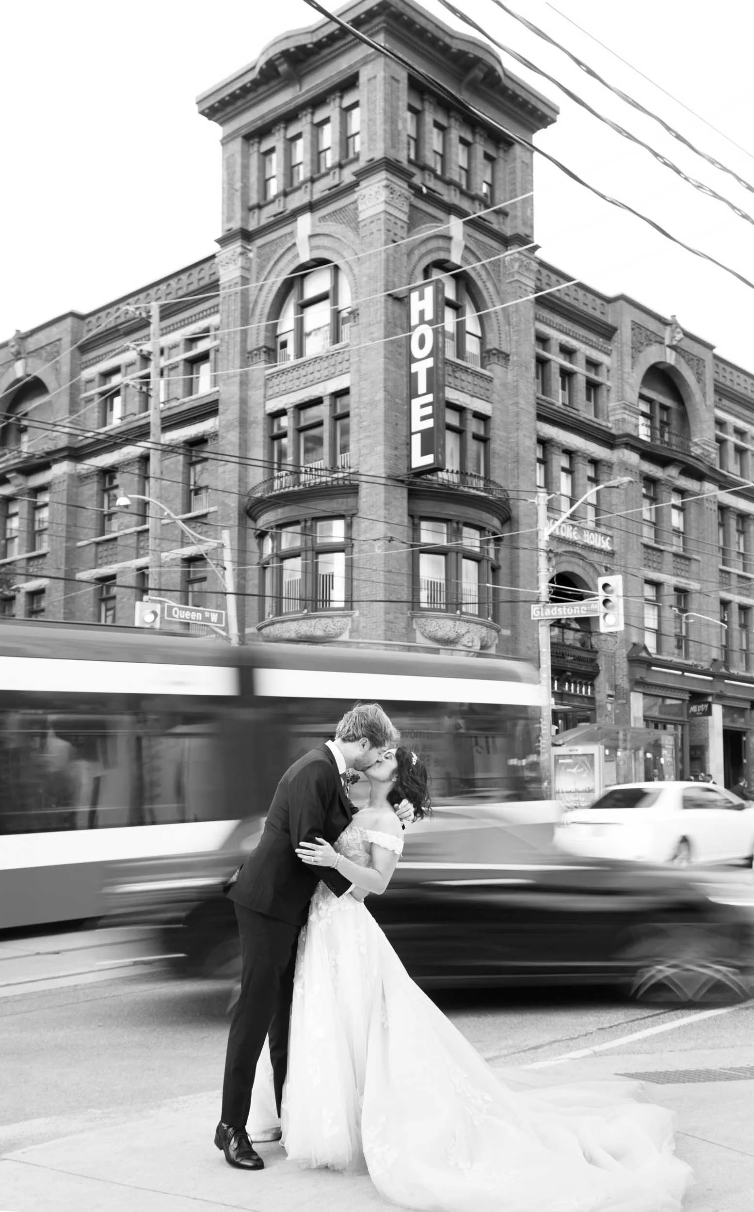 Black and white wedding portrait kiss at the Gladstone Hotel with motion blurred city traffic (Copy)