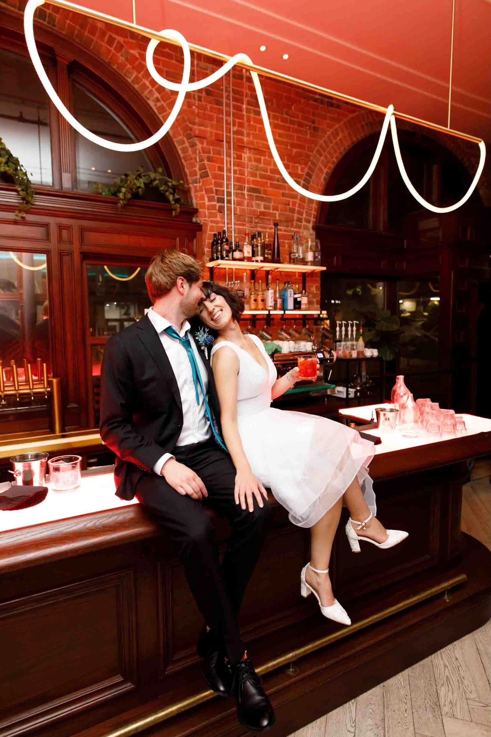 Bride and groom sitting together at the bar during a wedding at the Gladstone Hotel (Copy)