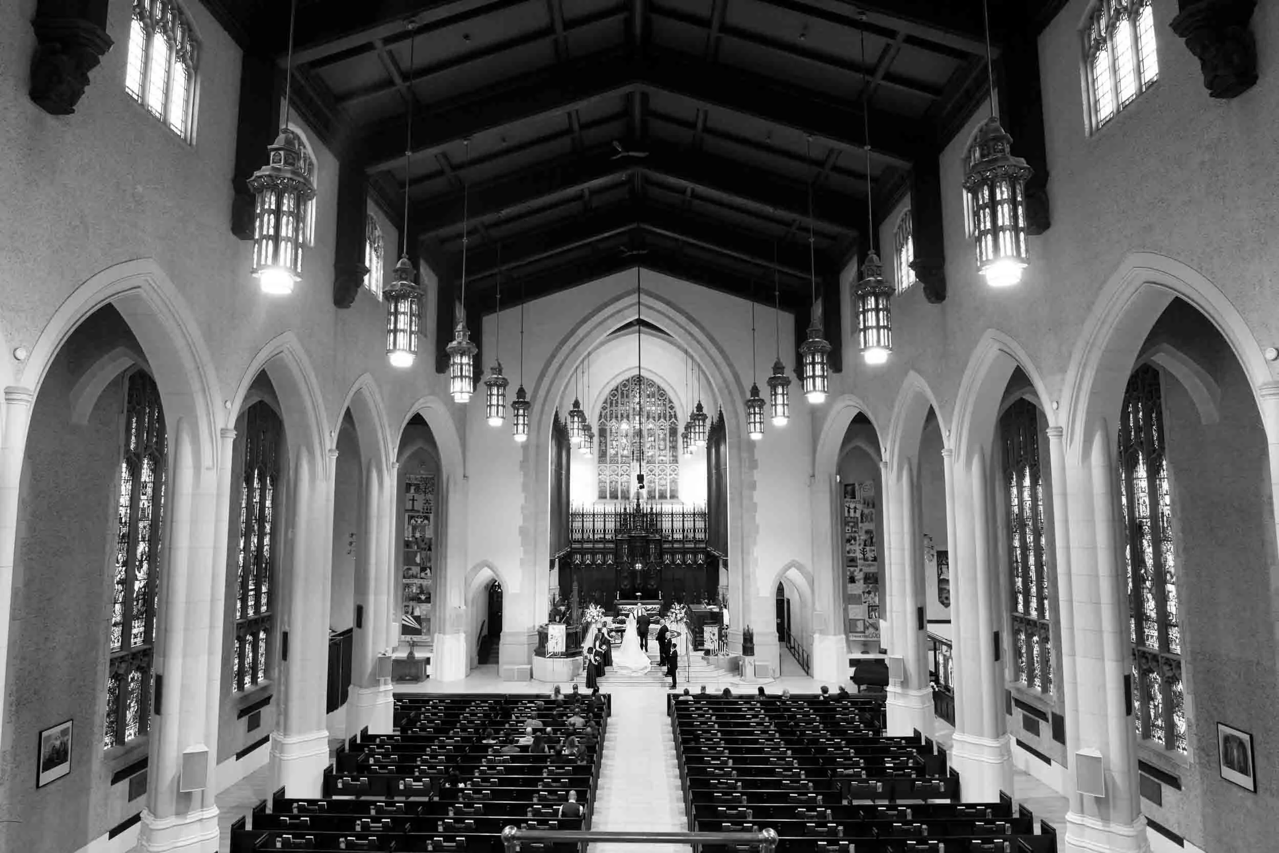 Wide black and white view of a wedding ceremony inside Metropolitan United Church in Toronto (Copy)