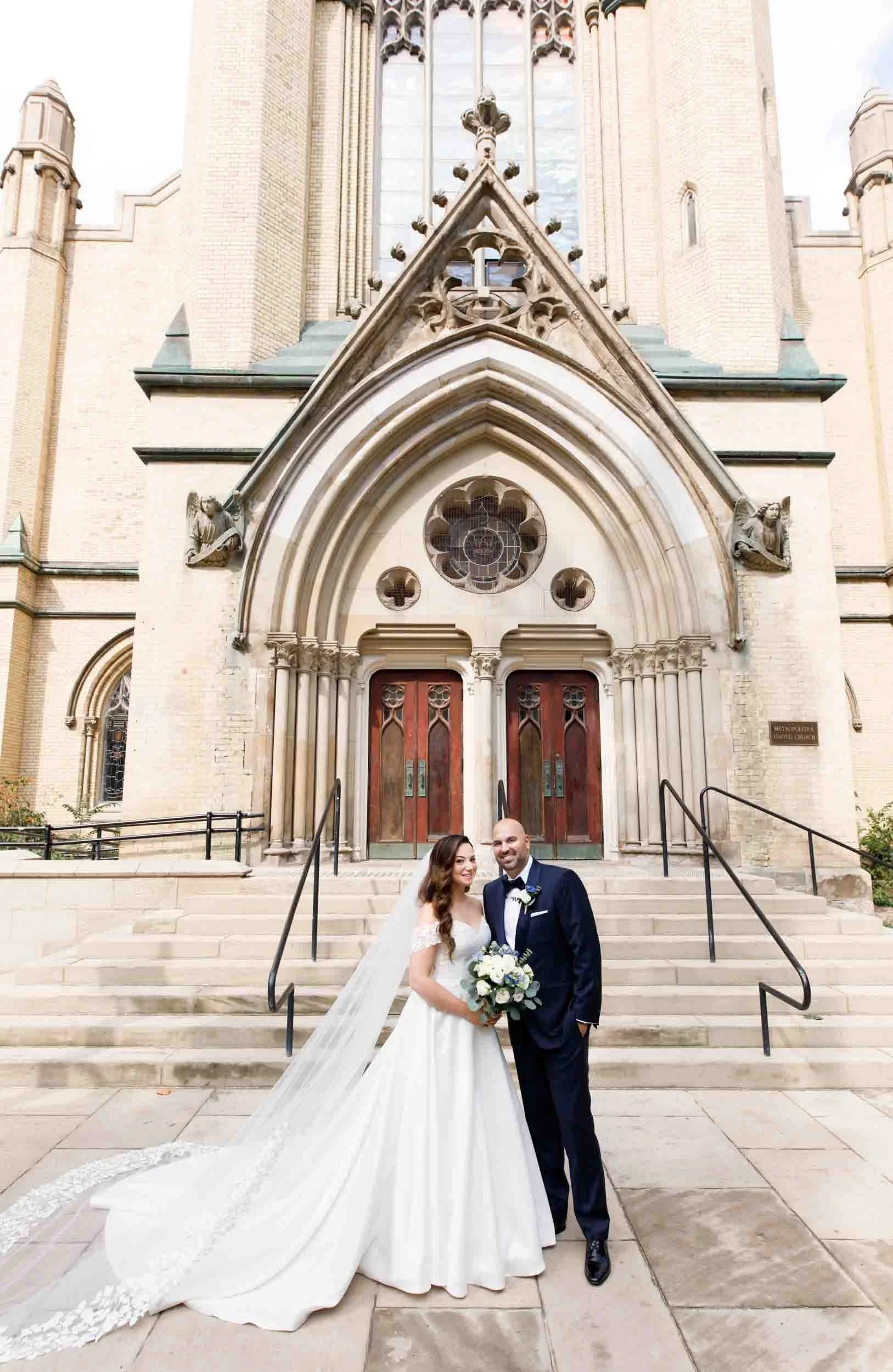 Bride and groom standing together outside the Metropolitan United Church (Copy)