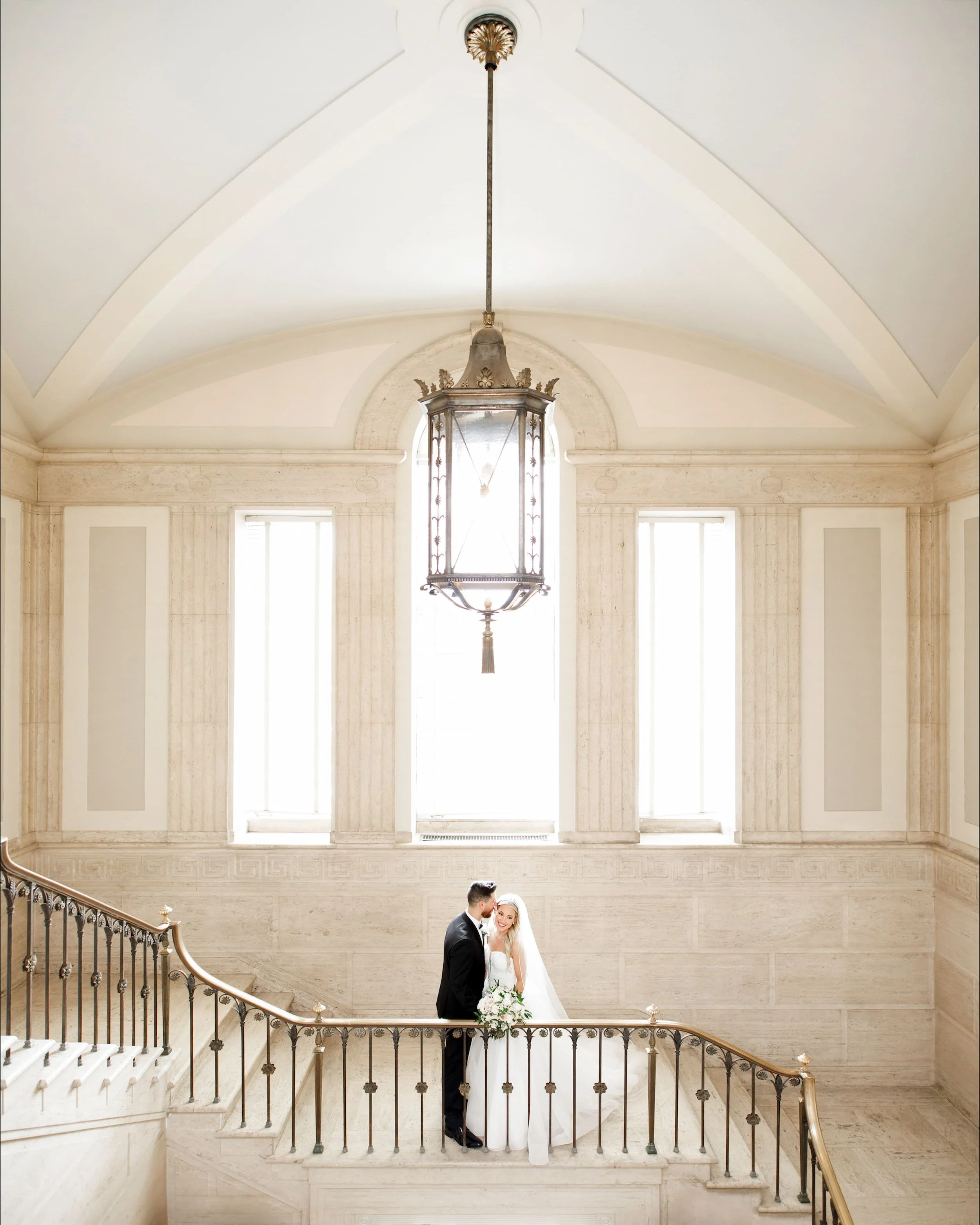 Wide shot of bride and groom kissing on the grand staircase at the David Dunlap Observatory in Richmond Hill (Copy)