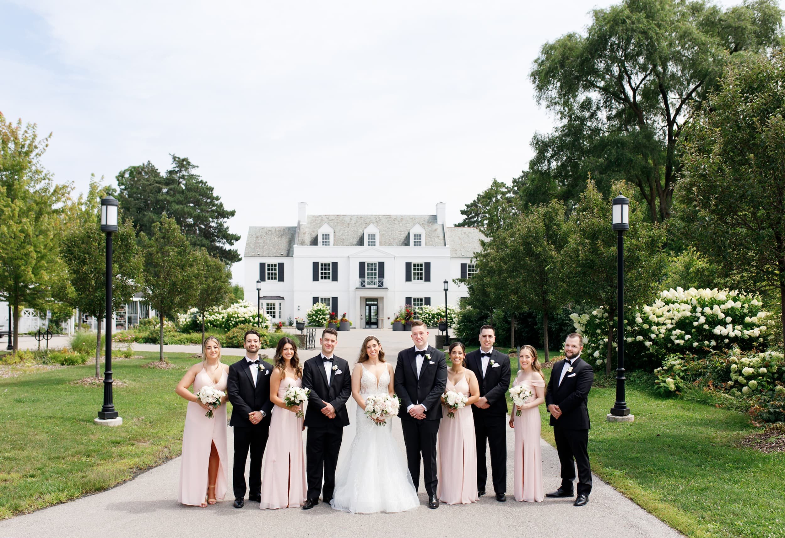 Full wedding party formal posing together in front of the Harding Waterfront Estate in Mississauga (Copy)