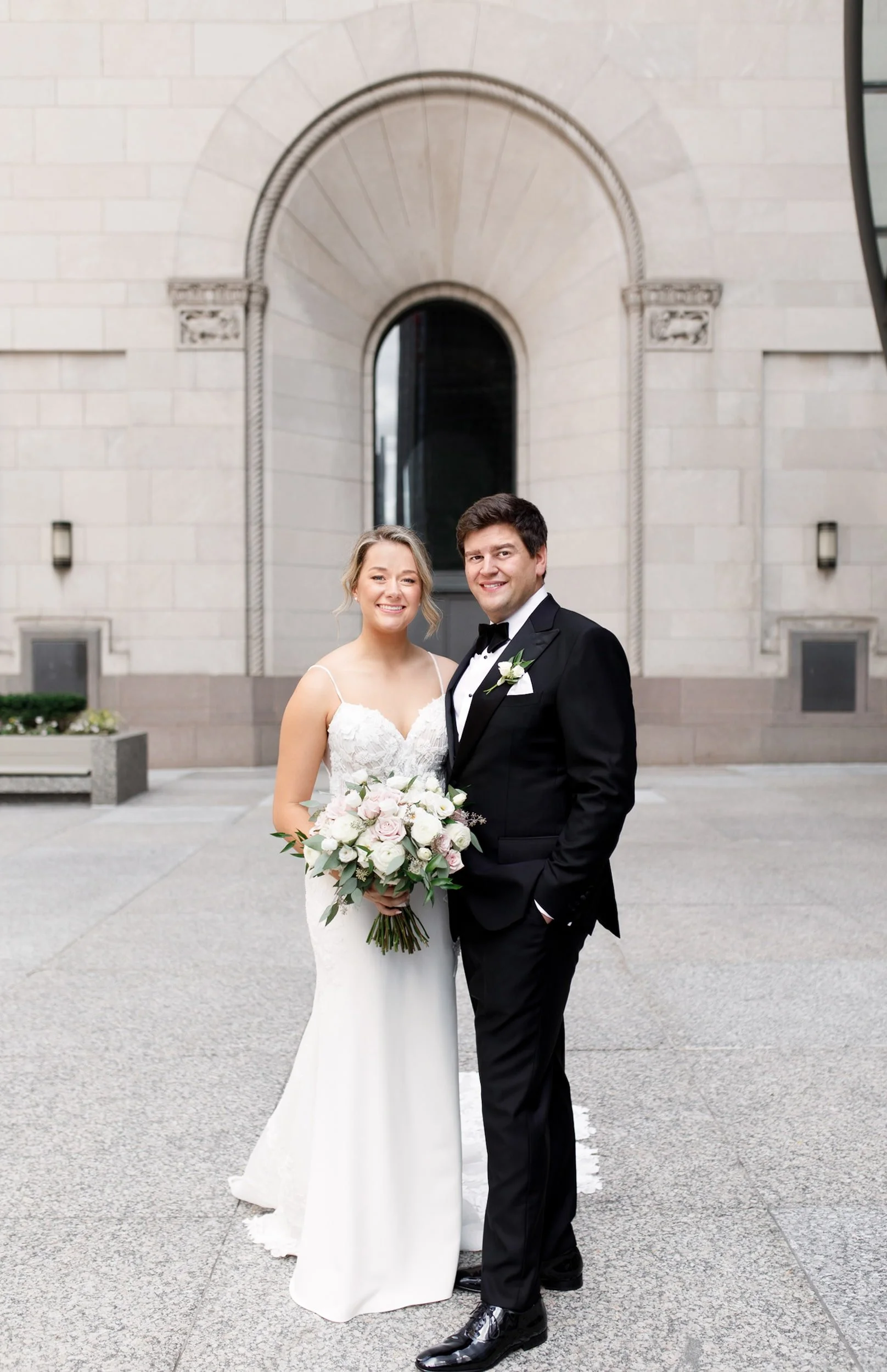 Bride and groom standing together outside a modern financial district bank building in downtown Toronto (Copy)
