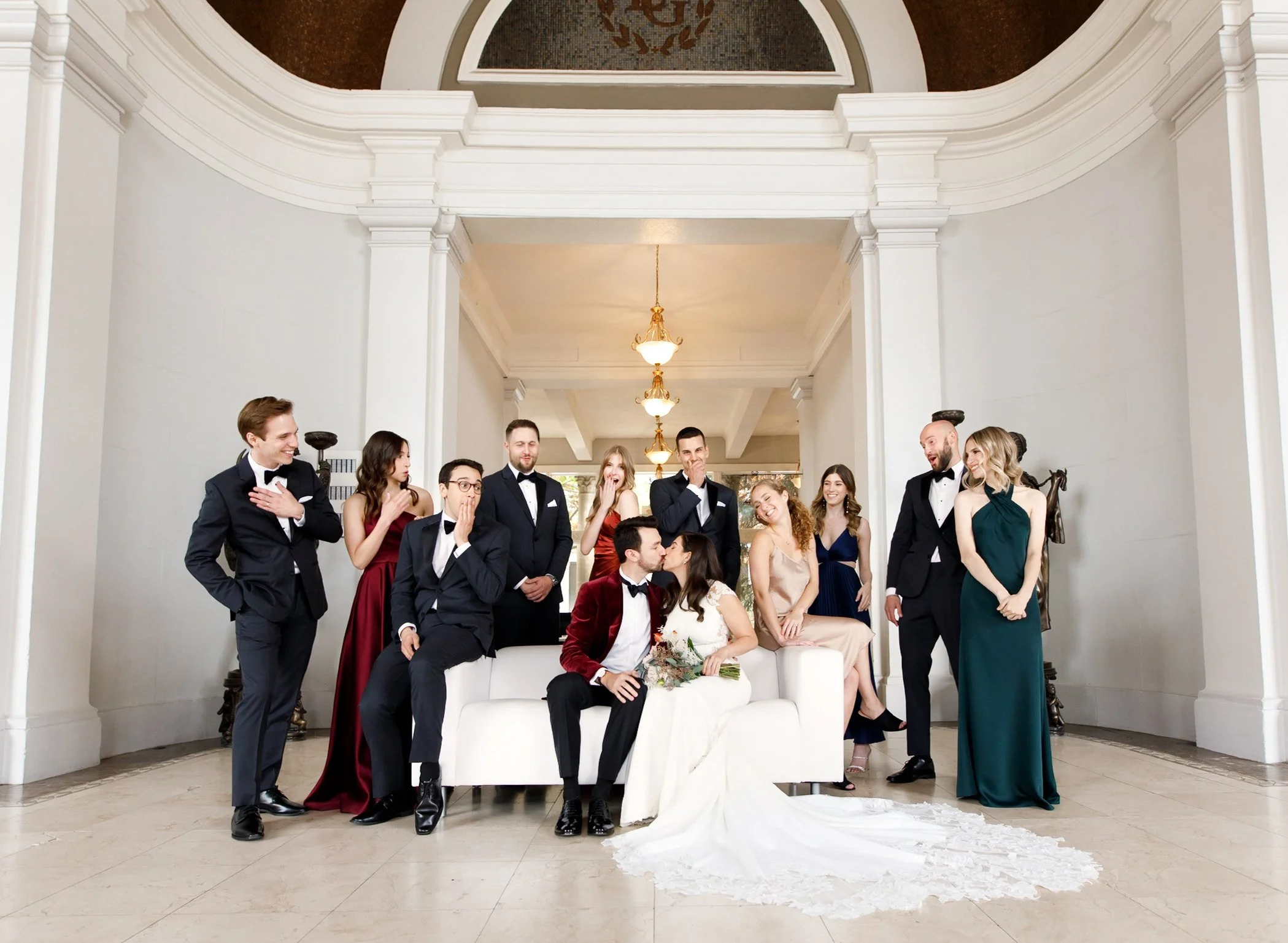 Wedding party portrait with kissing bride and groom in an elegant interior near the Liberty Grand in downtown Toronto (Copy)