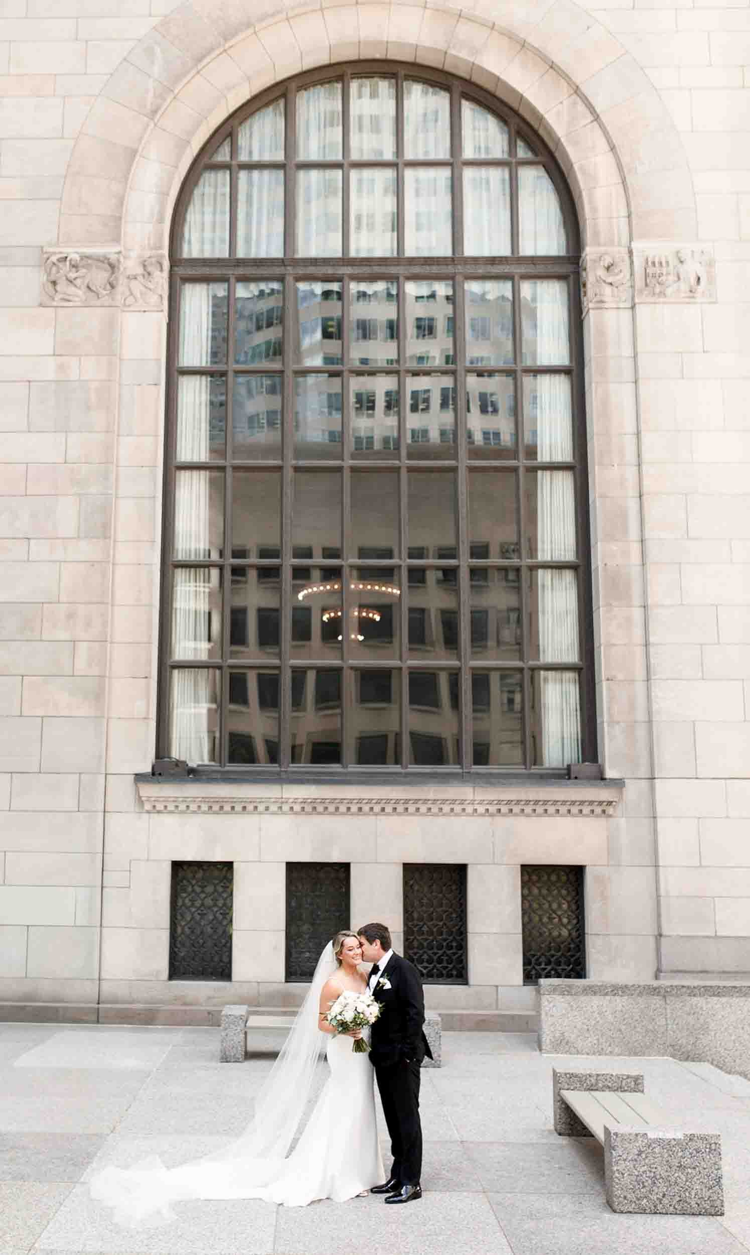 Bride and groom embracing in Toronto’s Financial District during a city wedding portrait (Copy)
