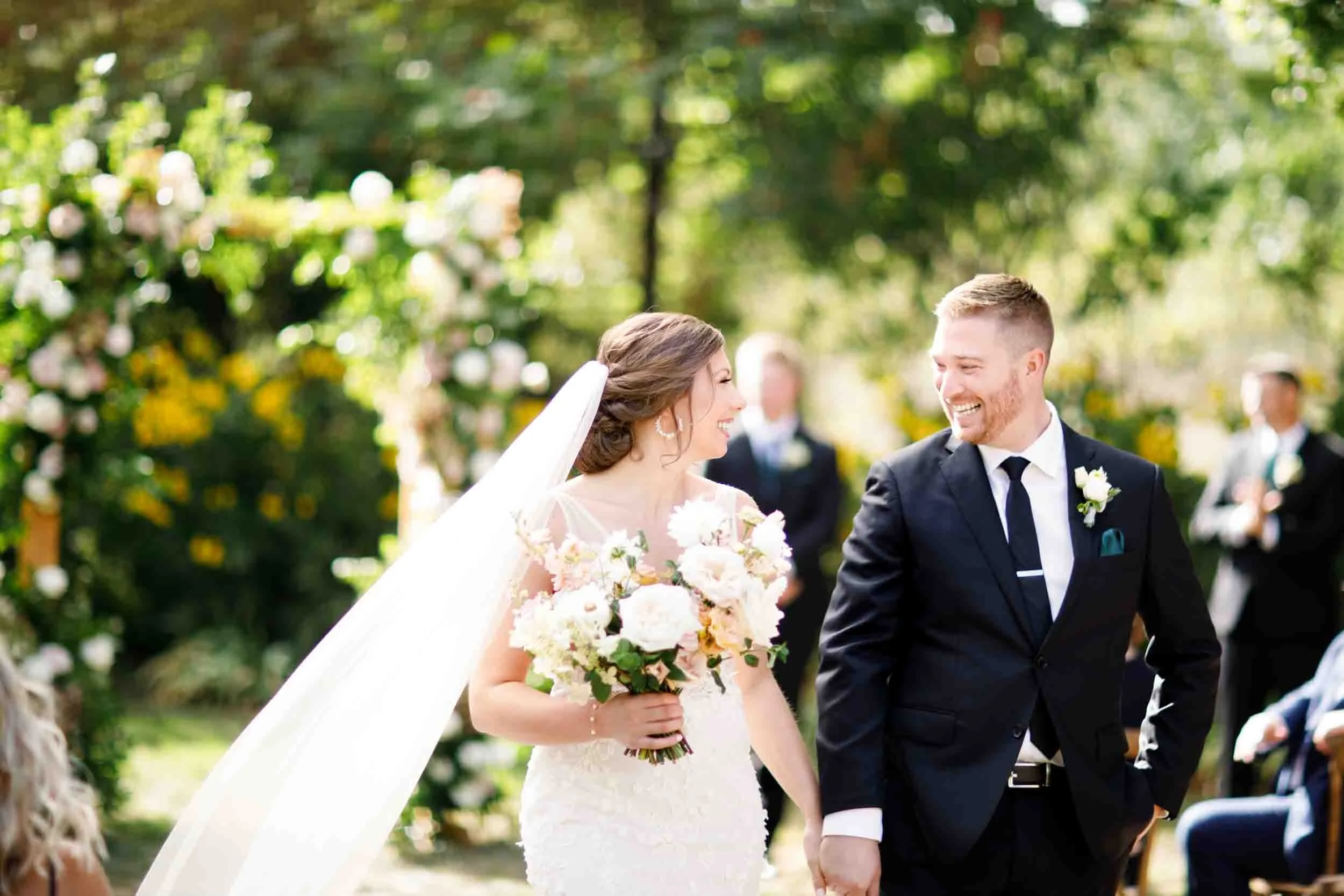 Joyful newlyweds cheering after their wedding ceremony in Beamsville, Ontario (Copy)