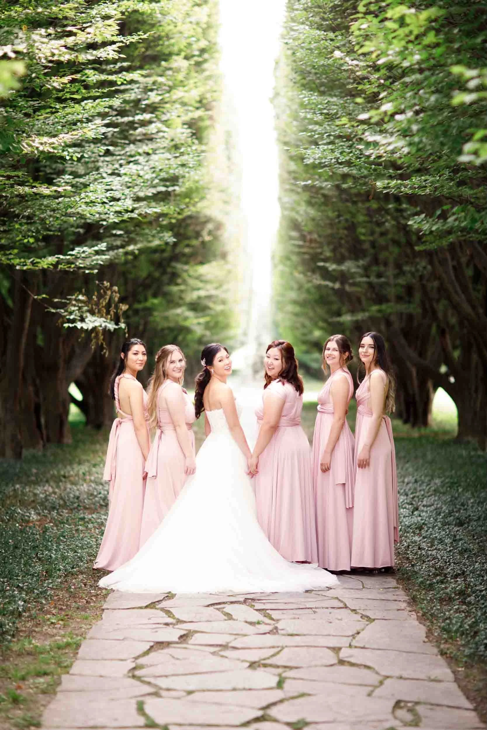Bridesmaids posing together with bride along a stone garden pathway at Royal Botanical Gardens wedding (Copy)