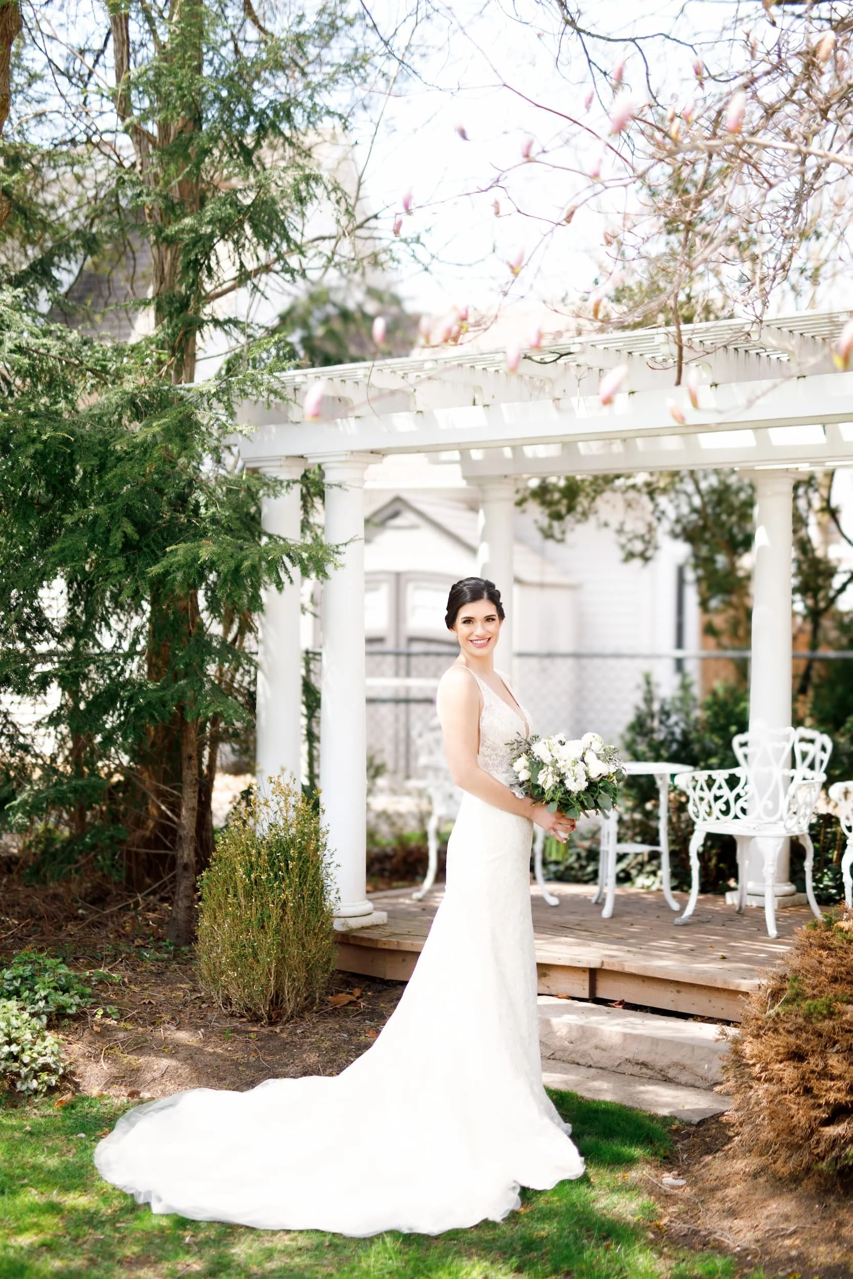 Bride in an elegant white wedding gown posing outside the Oban Inn in Niagara-on-the-Lake (Copy)
