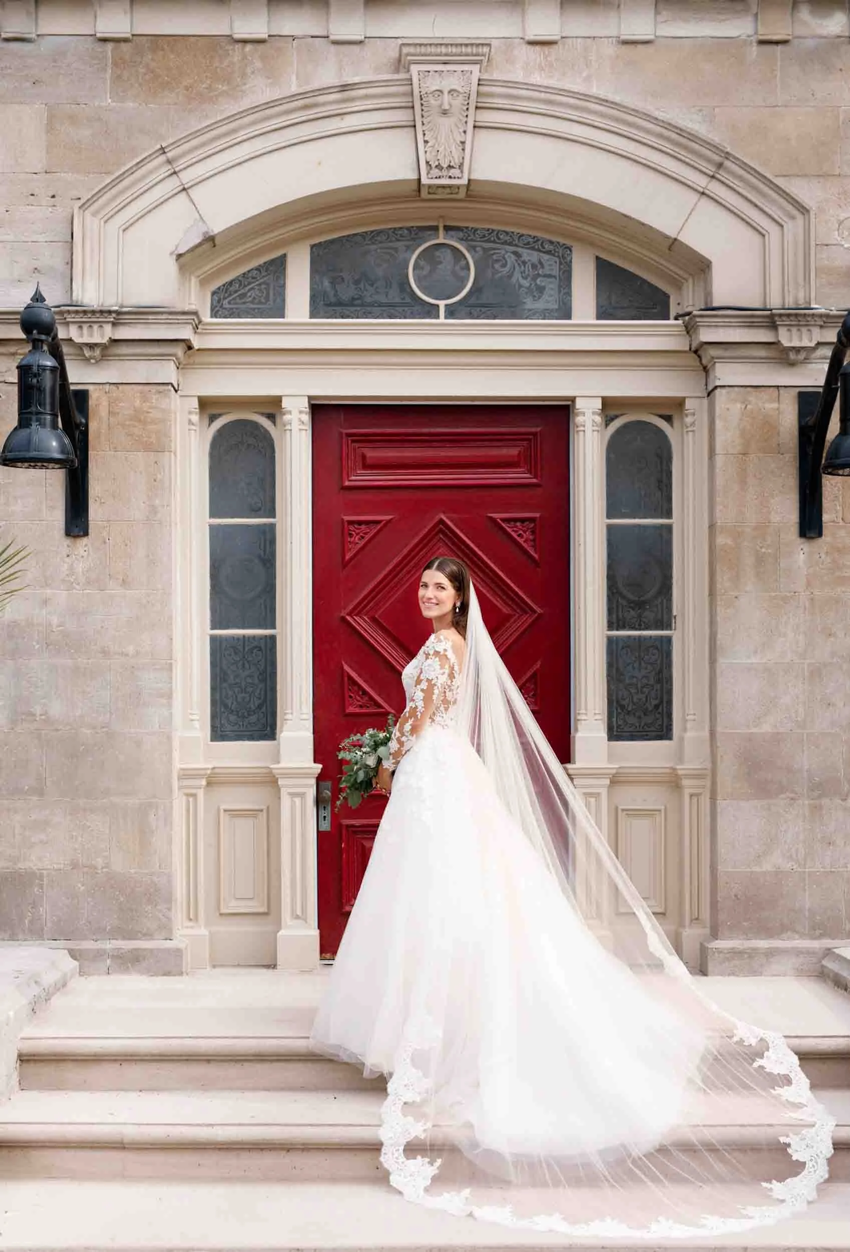 Bride standing in front of the iconic red door at Rodman Hall Boutique Hotel wedding in St. Catharines (Copy)