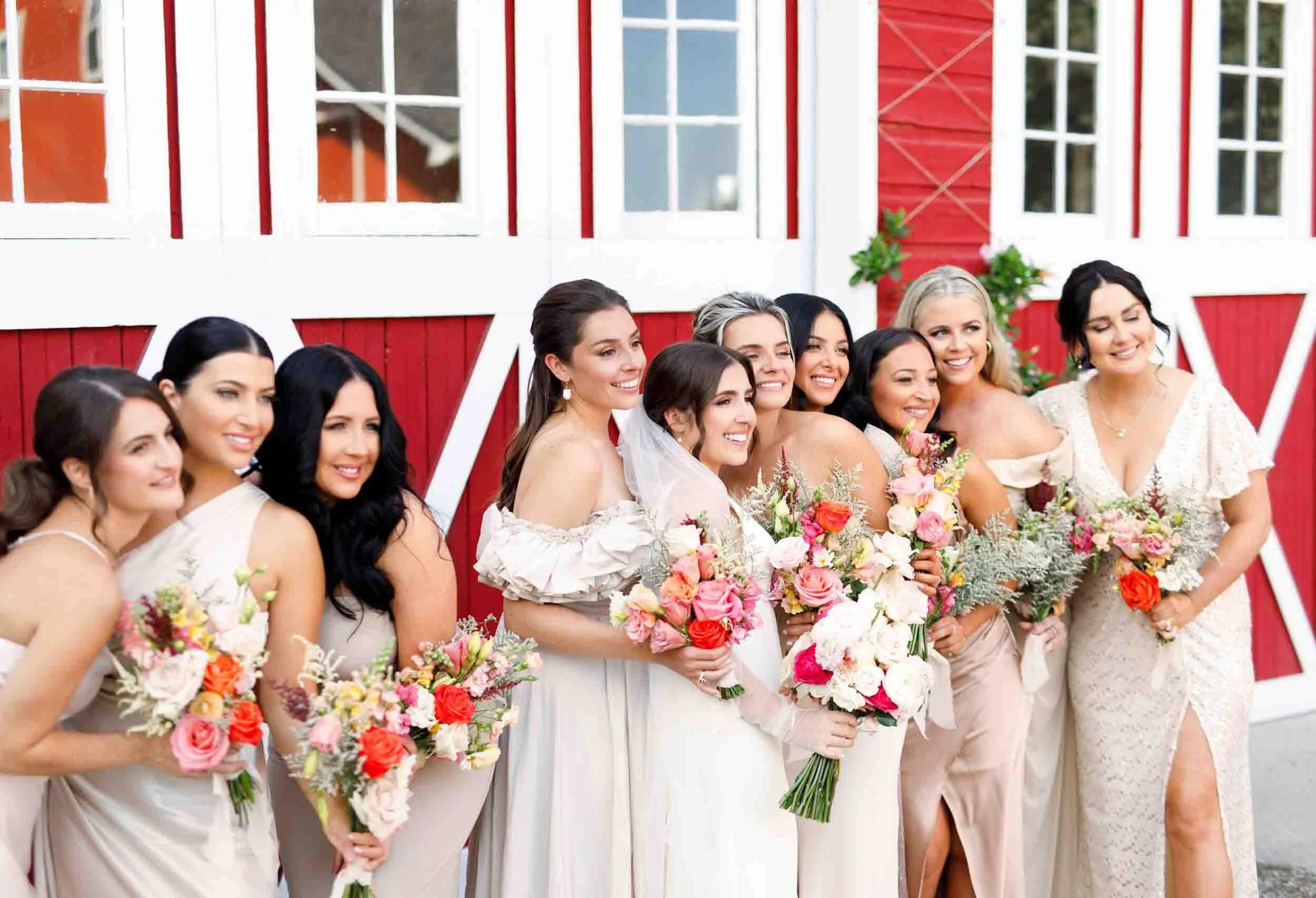 Bridesmaids holding colorful bouquets at Cherry Avenue Farms wedding in Vineland Station (Copy)