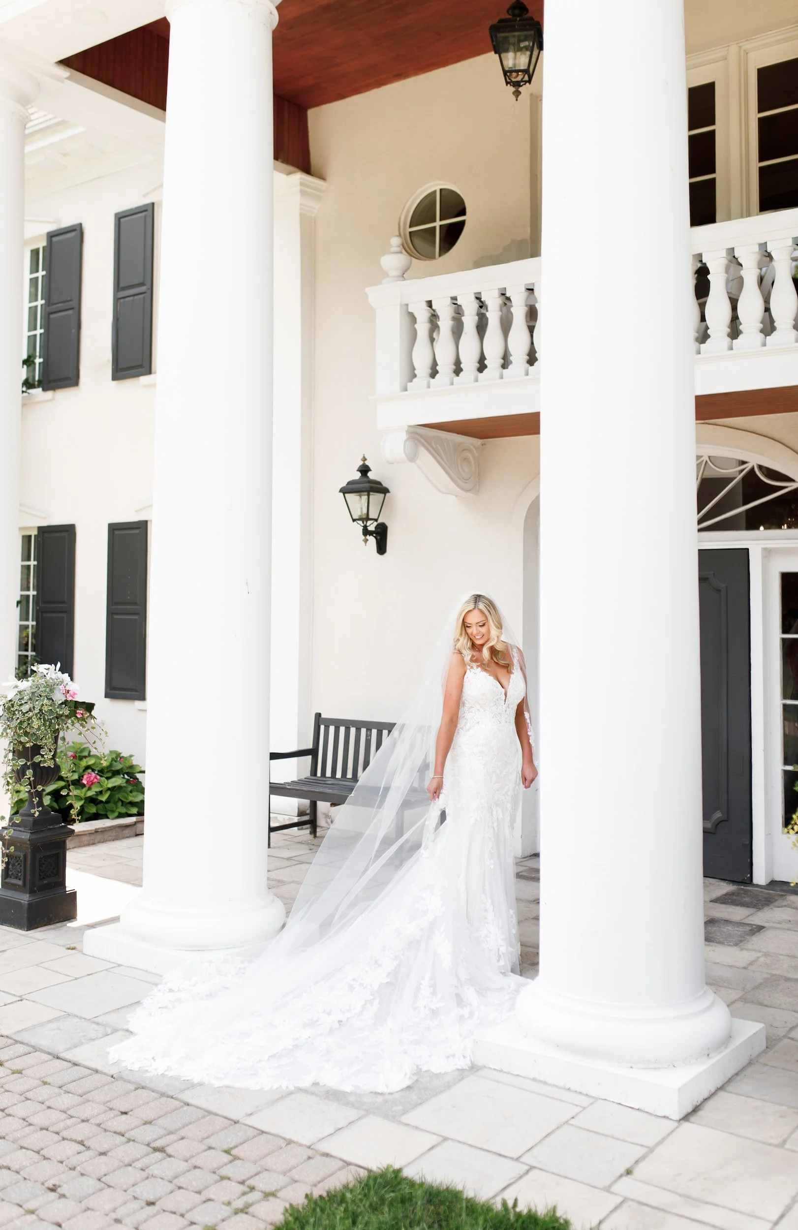 Bride portrait beneath white columns at Riverbend Inn wedding in Niagara-on-the-Lake (Copy)