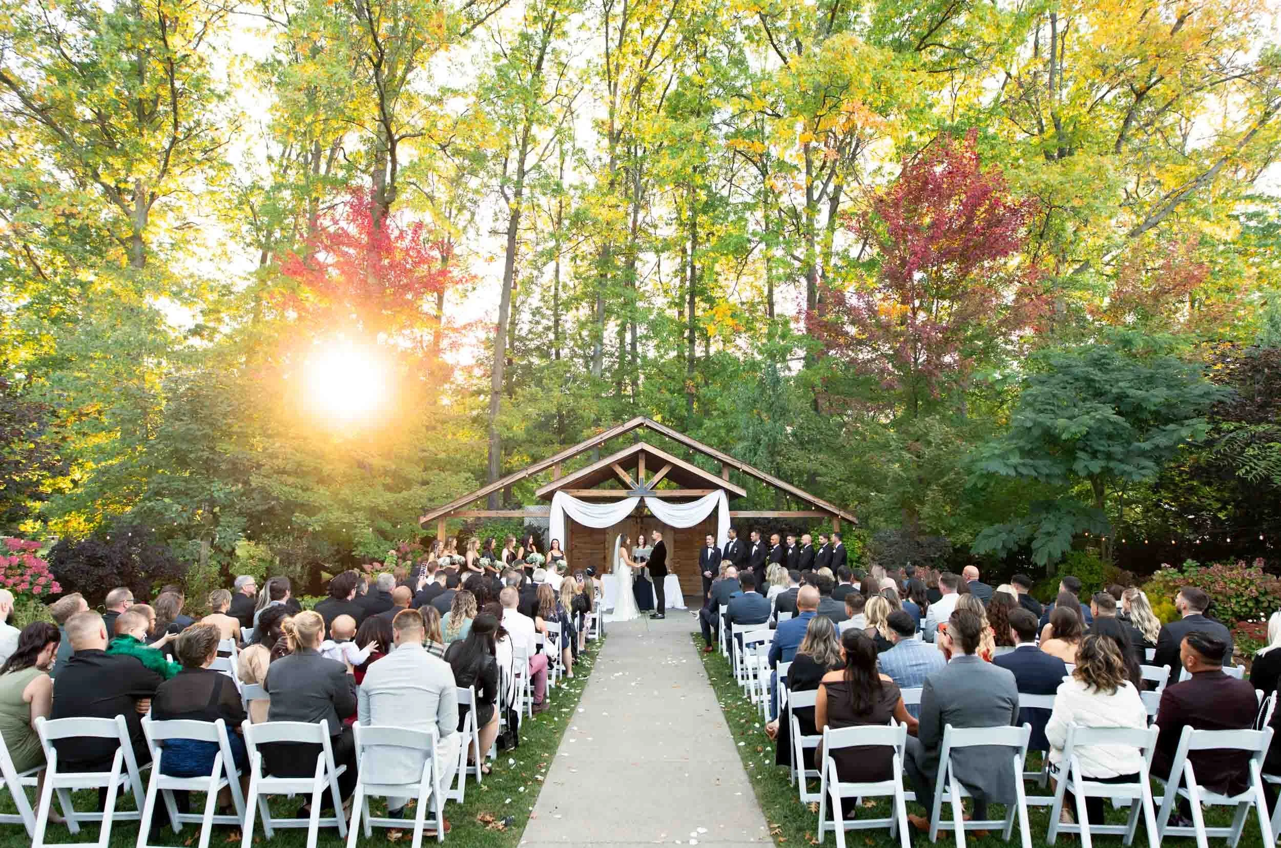 Outdoor sunset wedding ceremony at Club Roma in St. Catharines surrounded by autumn trees (Copy)