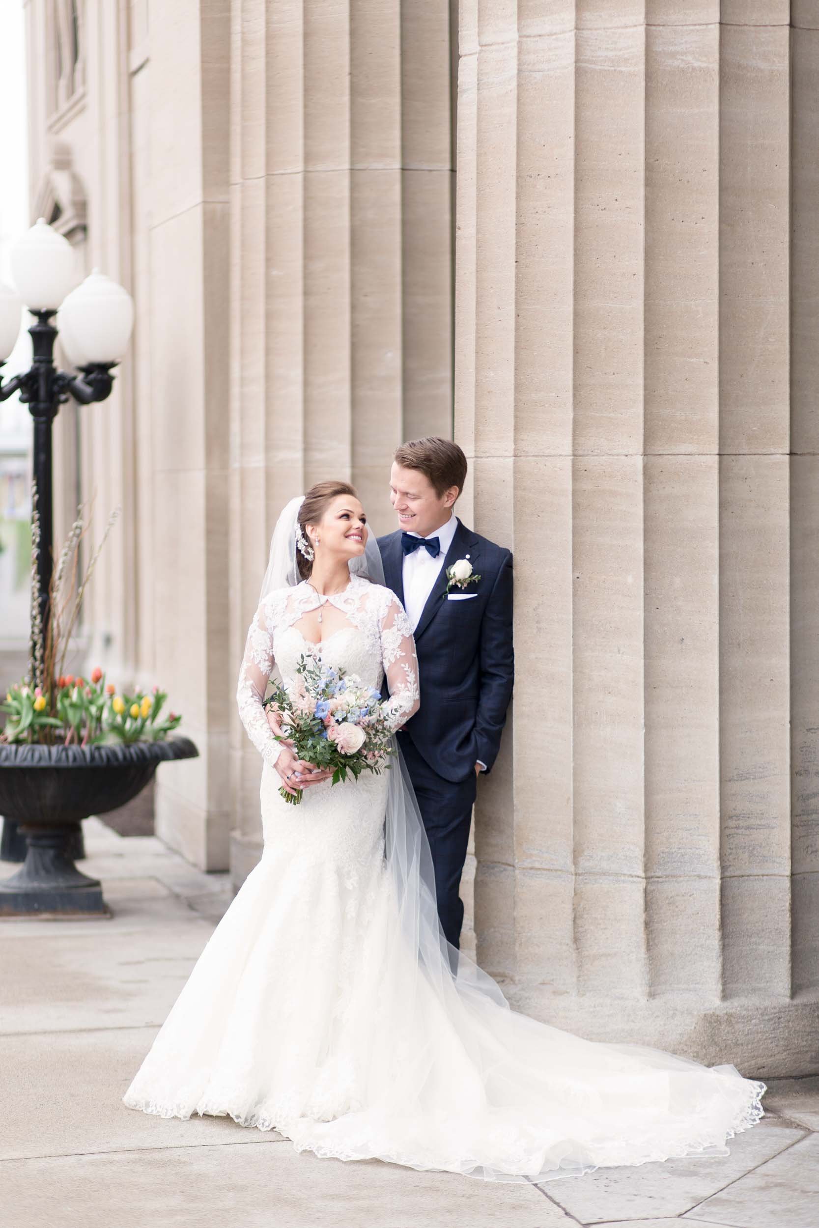 Bride and groom portrait beneath stone columns at LIUNA Station in Hamilton (Copy)