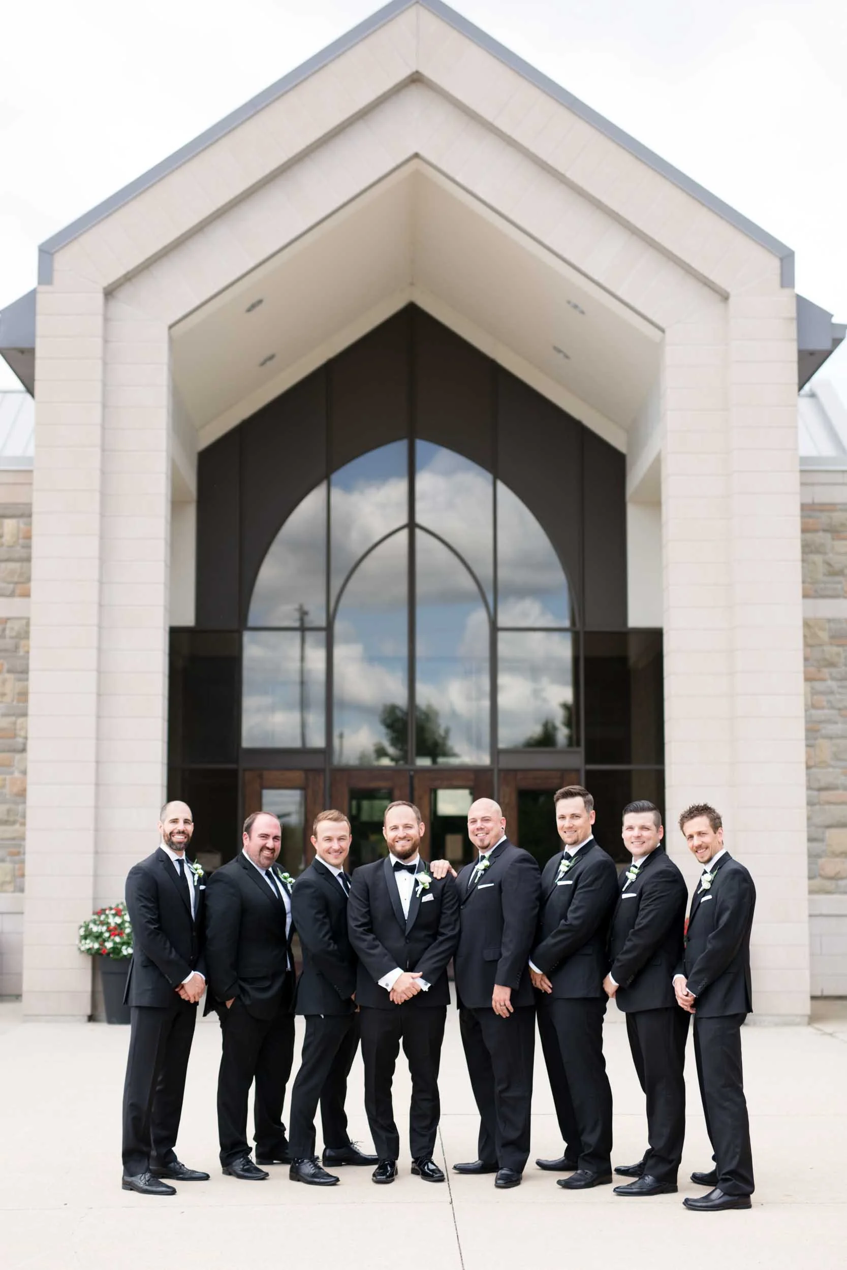 Groomsmen lined up outside modern Hamilton church before ceremony (Copy)