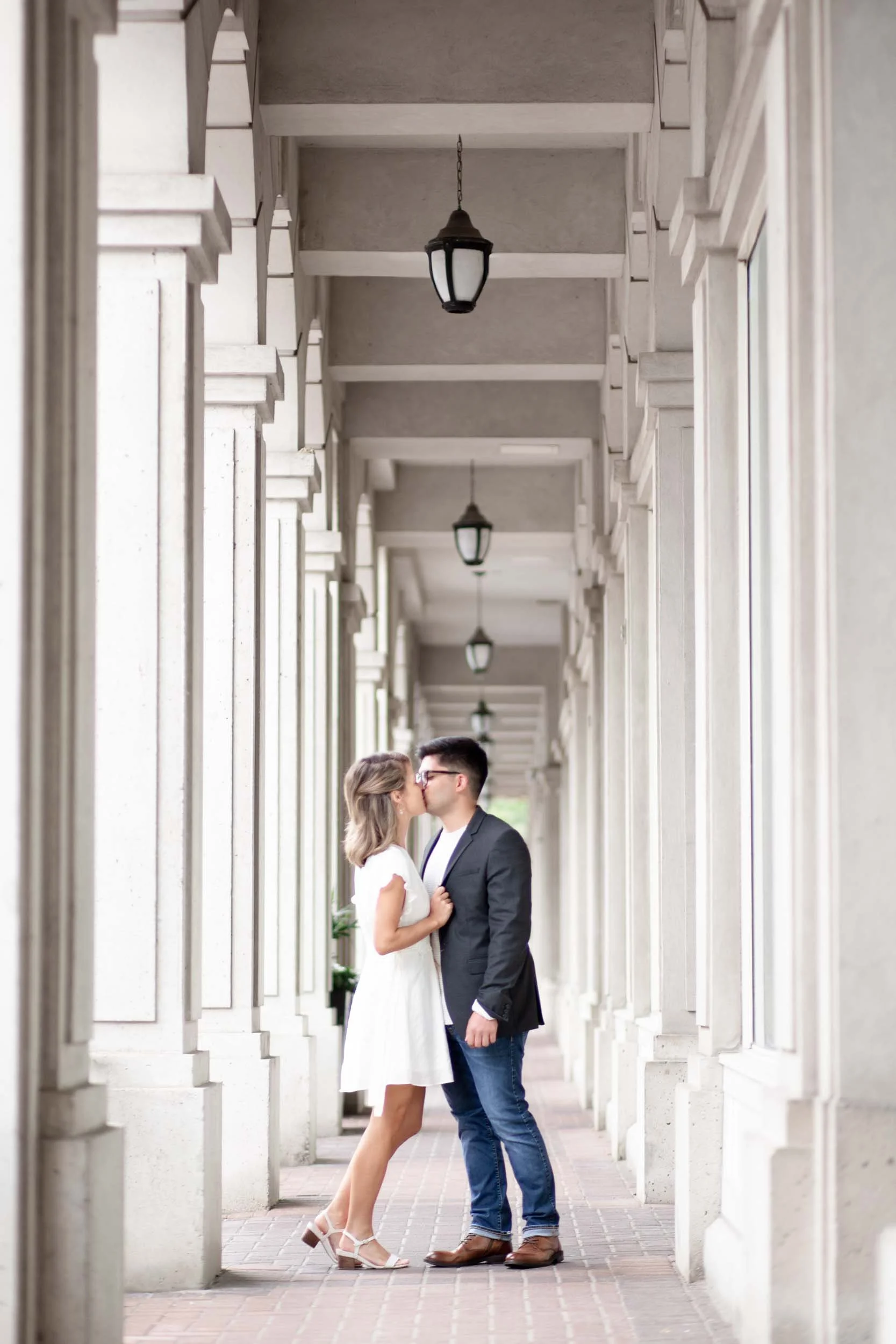 Couple portrait beneath colonnade at Village Square in Burlington, Ontario (Copy)