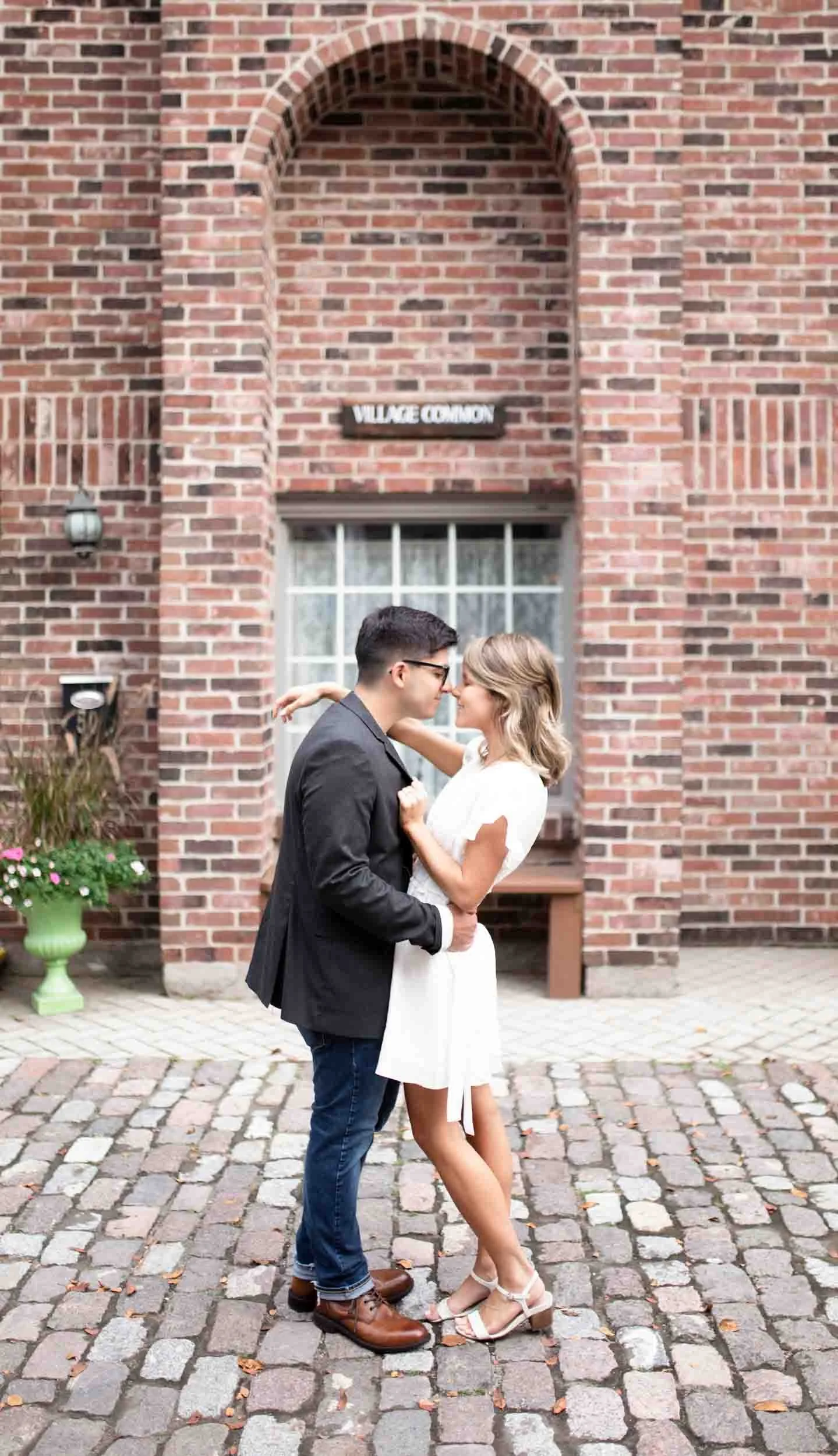 Couple embracing in brick archway at Village Square in Burlington (Copy)