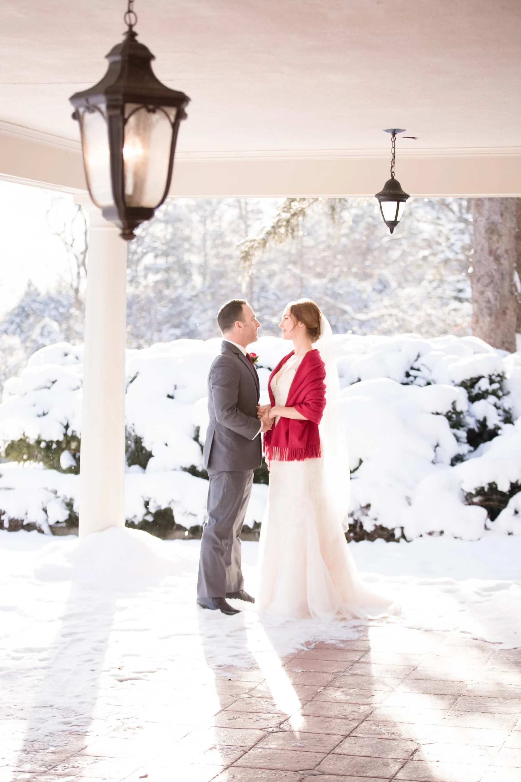 Winter wedding portrait beneath covered walkway at Paletta Mansion in Burlington (Copy)