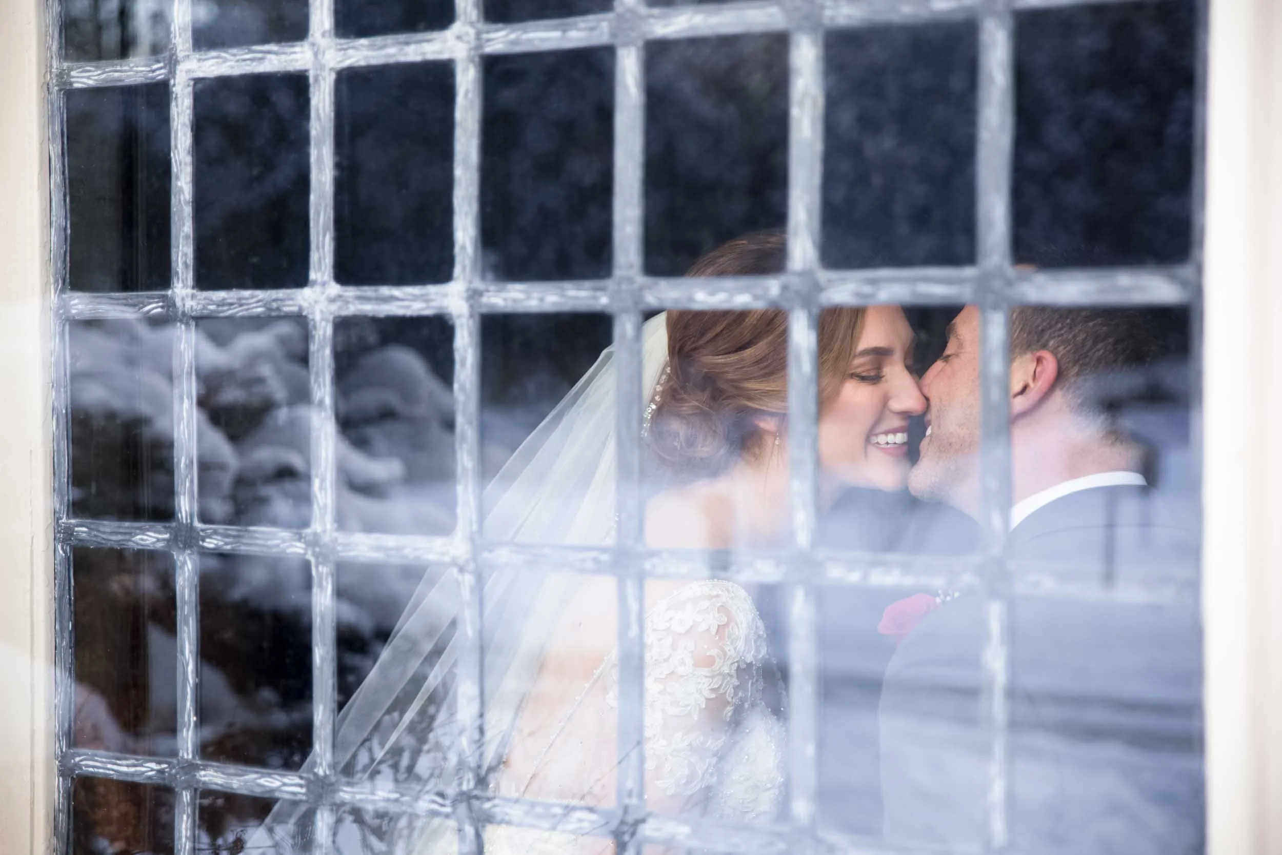 Intimate winter wedding portrait through antique window panes at Paletta Mansion in Burlington (Copy)