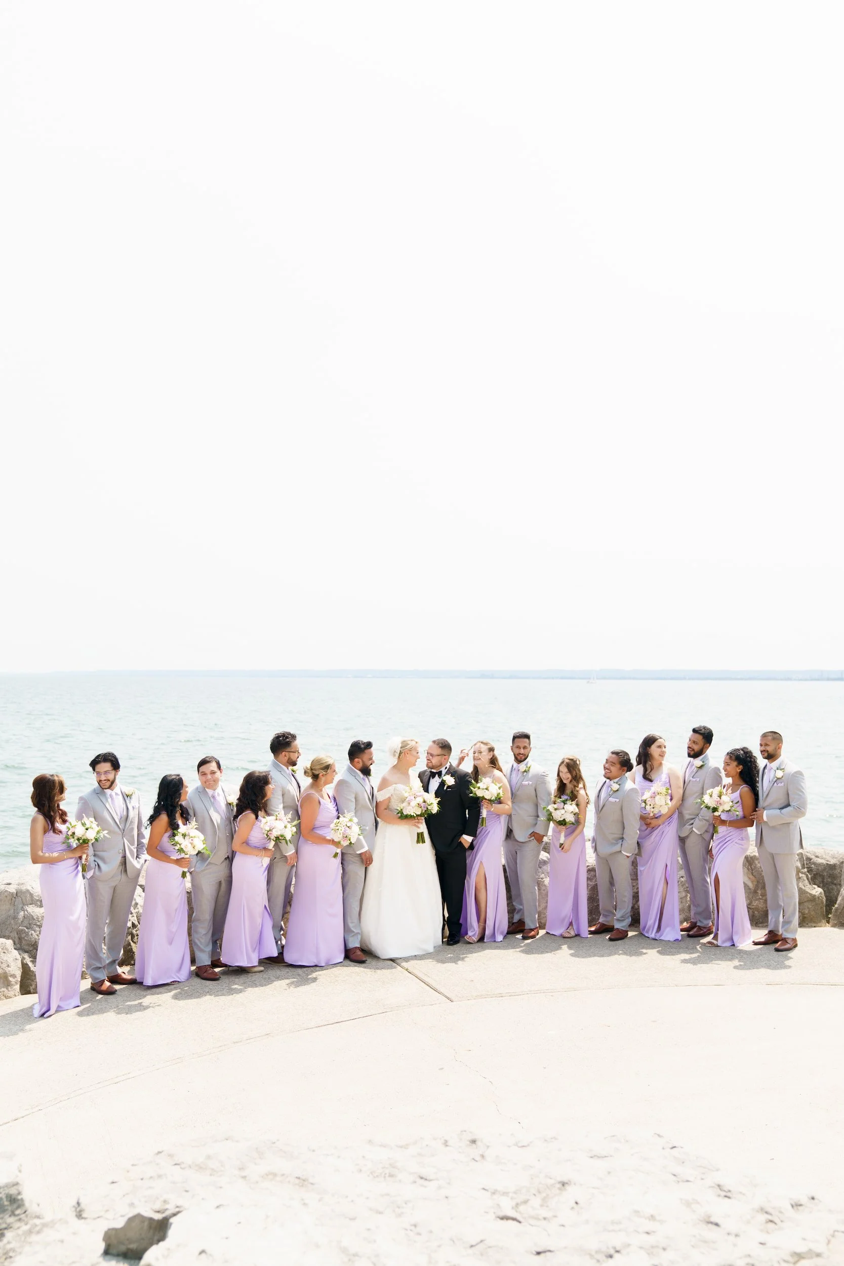 Bridesmaids in lavender dresses posing at Spencer Smith Park waterfront in Burlington (Copy)