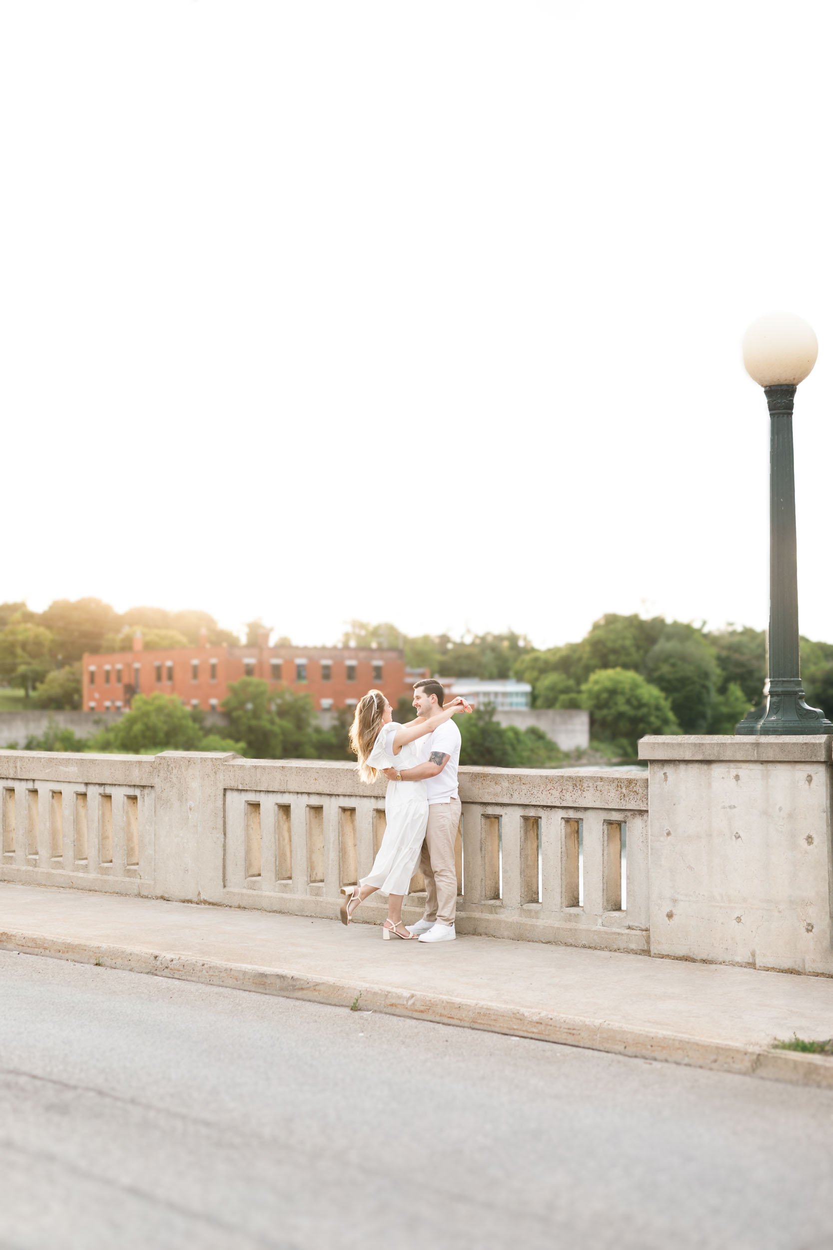 Bride and groom to be embracing at sunset together near Mill Race Park during a Cambridge engagement shoot (Copy)