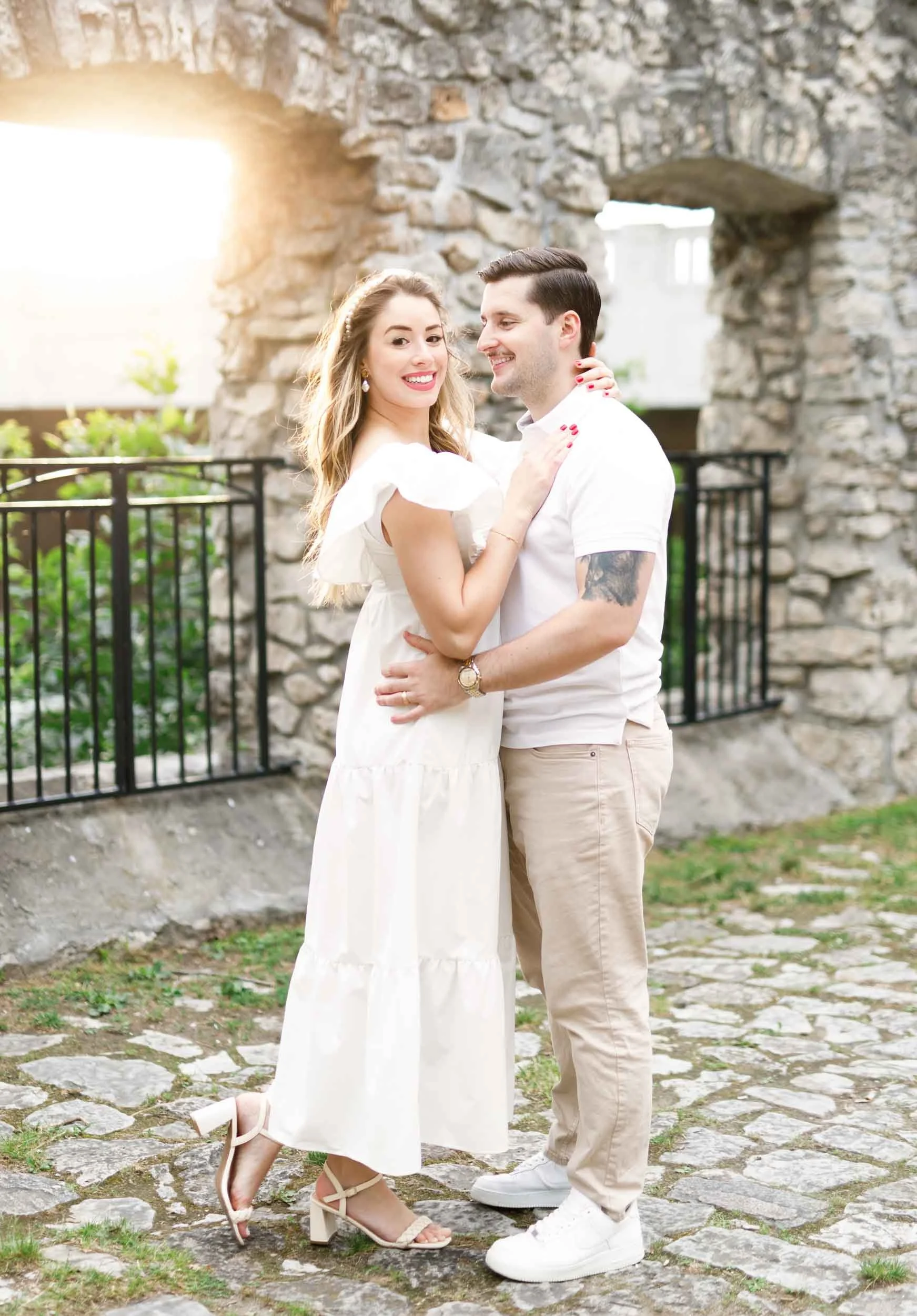 Bride and groom to be posing for engagement shots against historic stone ruins at Mill Race Park in Cambridge, Ontario (Copy)