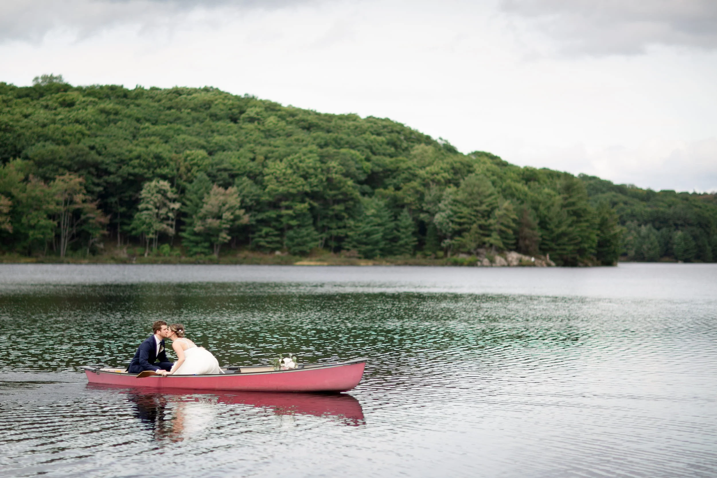 Same-sex couple canoeing together during a relaxed wedding portrait session on a lake in Cambridge, Ontario (Copy)