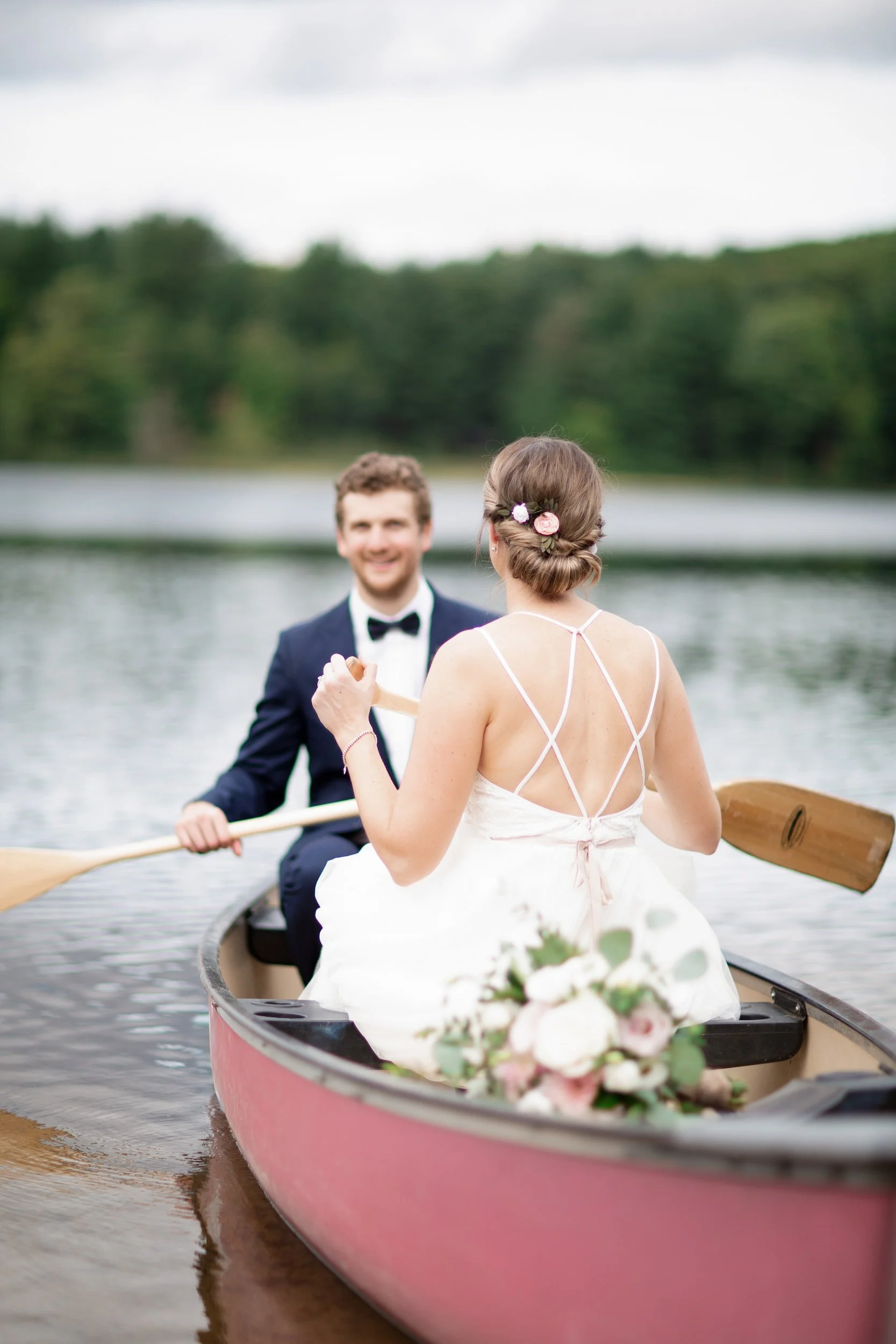 Candid wedding portrait of a couple in a canoe on a peaceful Cambridge lake in the Waterloo Region, Ontario (Copy)