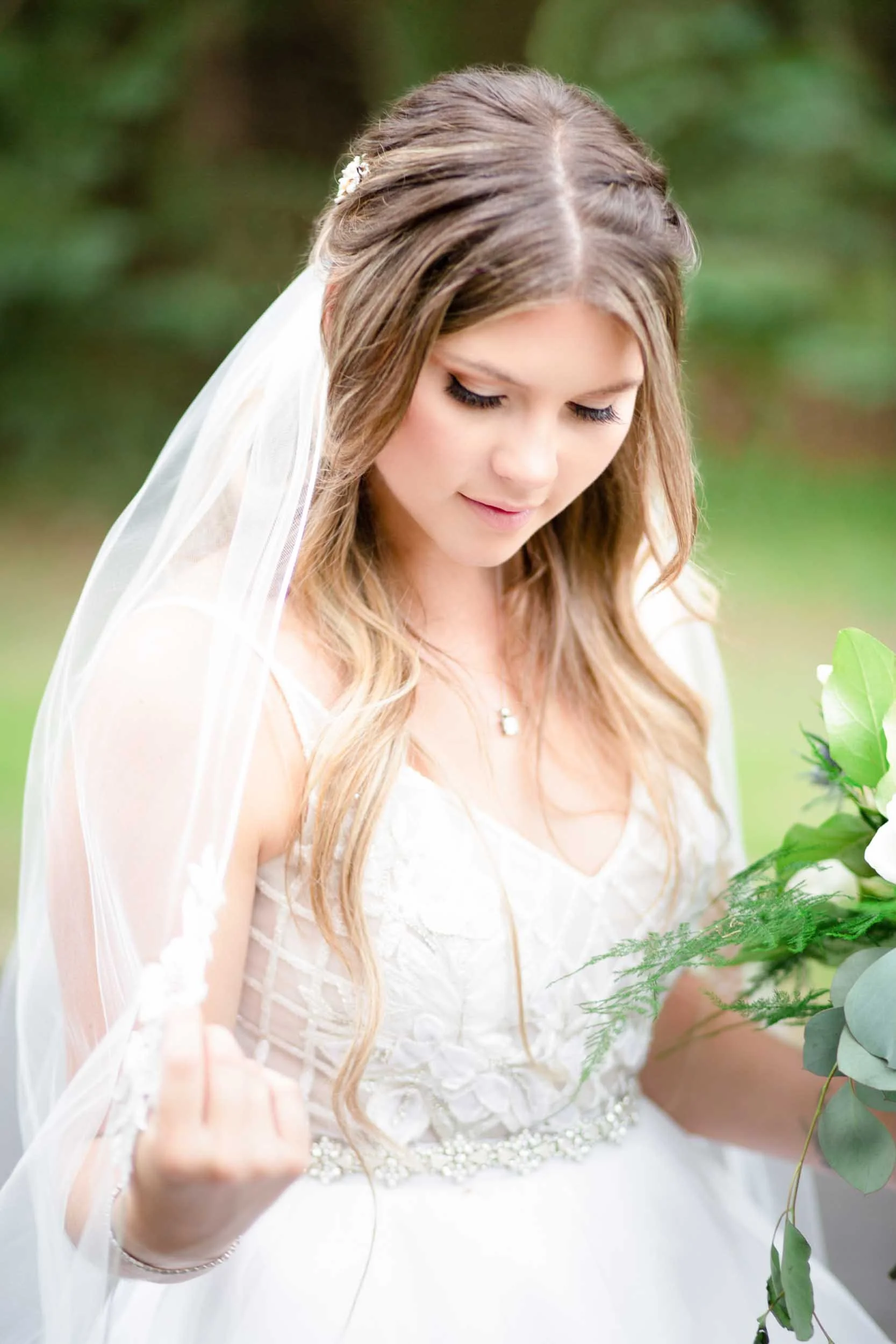 Bride adjusting her veil during wedding portraits at Roseville Estate Winery in Cambridge, Ontario (Copy)