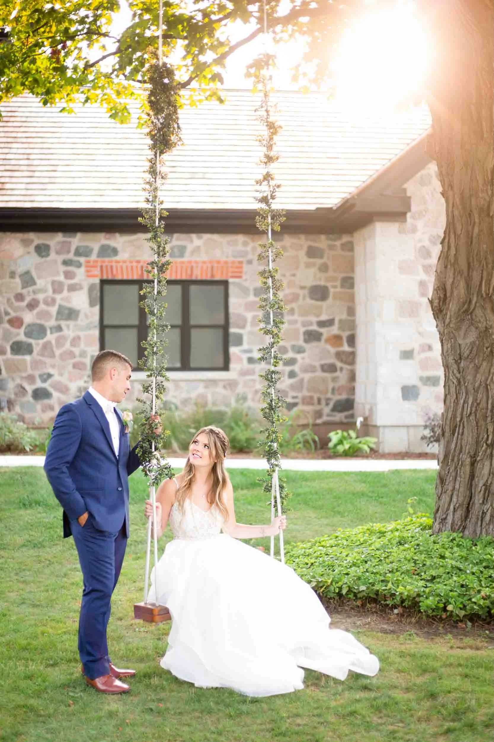 Bride and groom on the swing together on the lawn at Roseville Estate Winery during a Cambridge wedding (Copy)