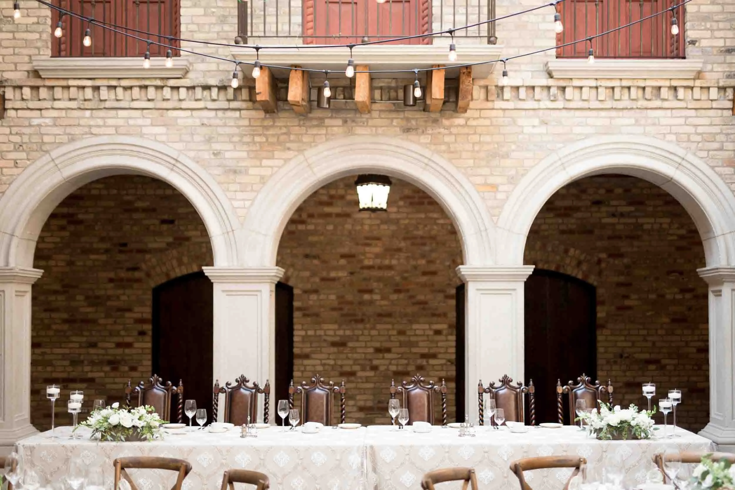 Wedding reception setup beneath the arched stone courtyard at Hacienda Sereda in the Waterloo Region (Copy)