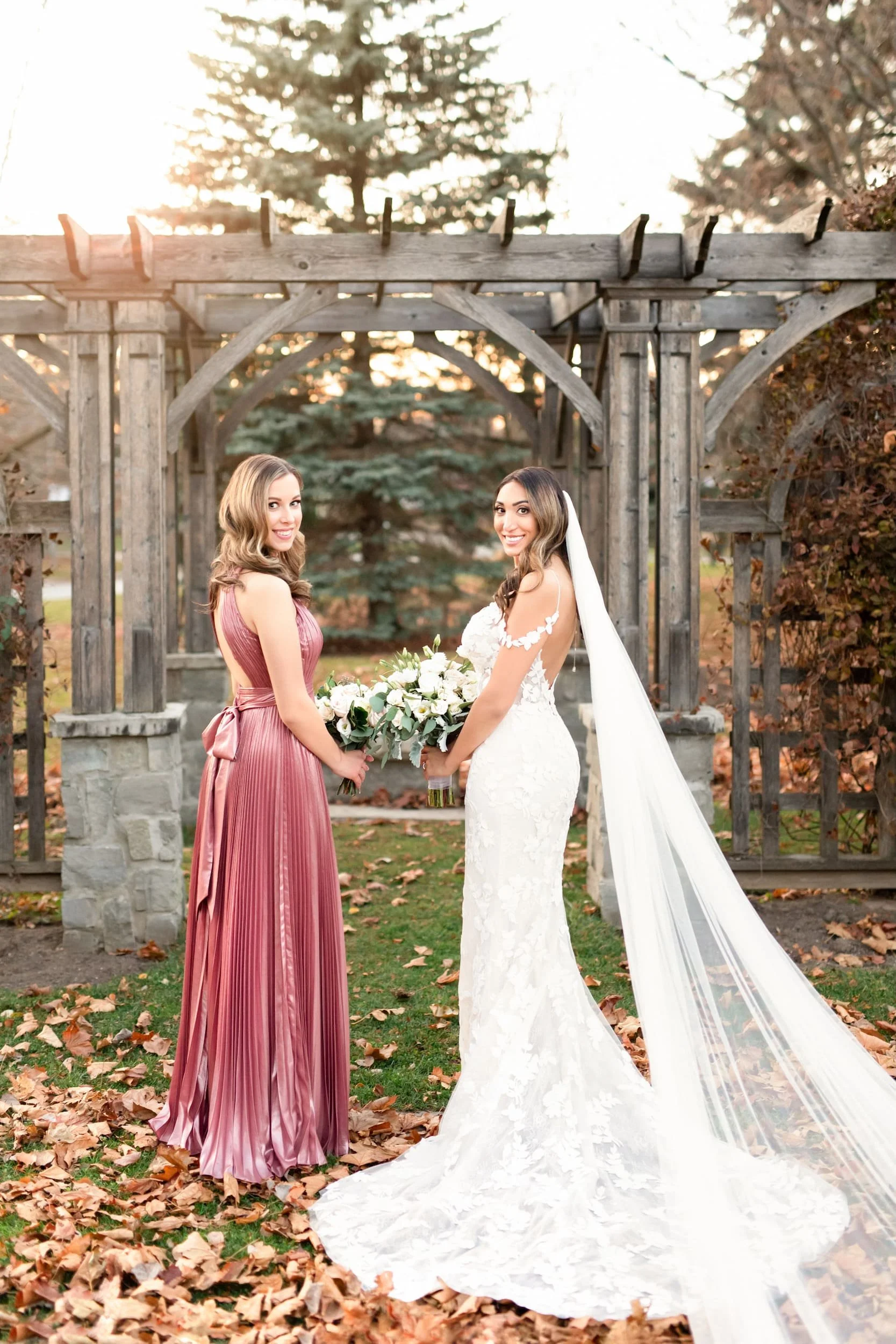 Bride and Maid of Honour holding bouquets during dusk wedding portraits at Rockway Gardens in the Waterloo Region, Ontario (Copy)