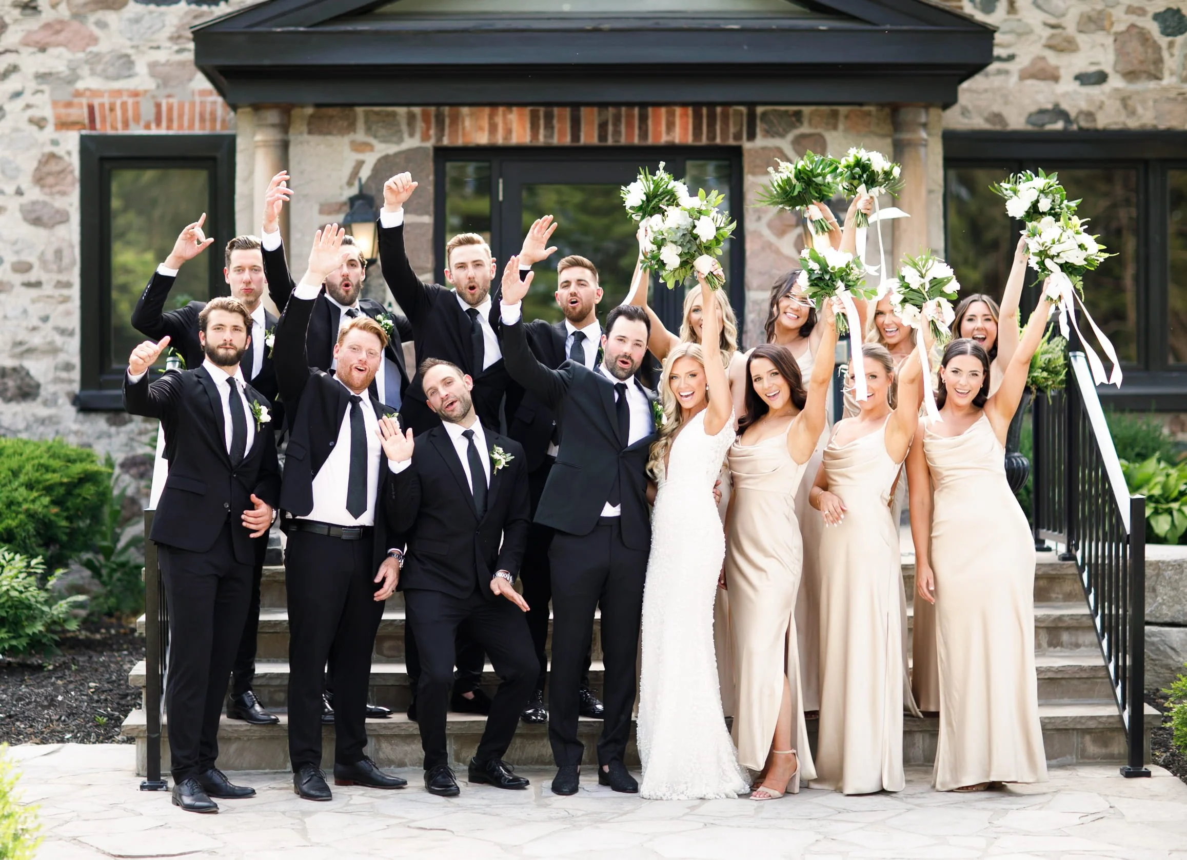 Wedding party celebrating and cheering together outside Roseville Estate Winery during a Cambridge wedding (Copy)